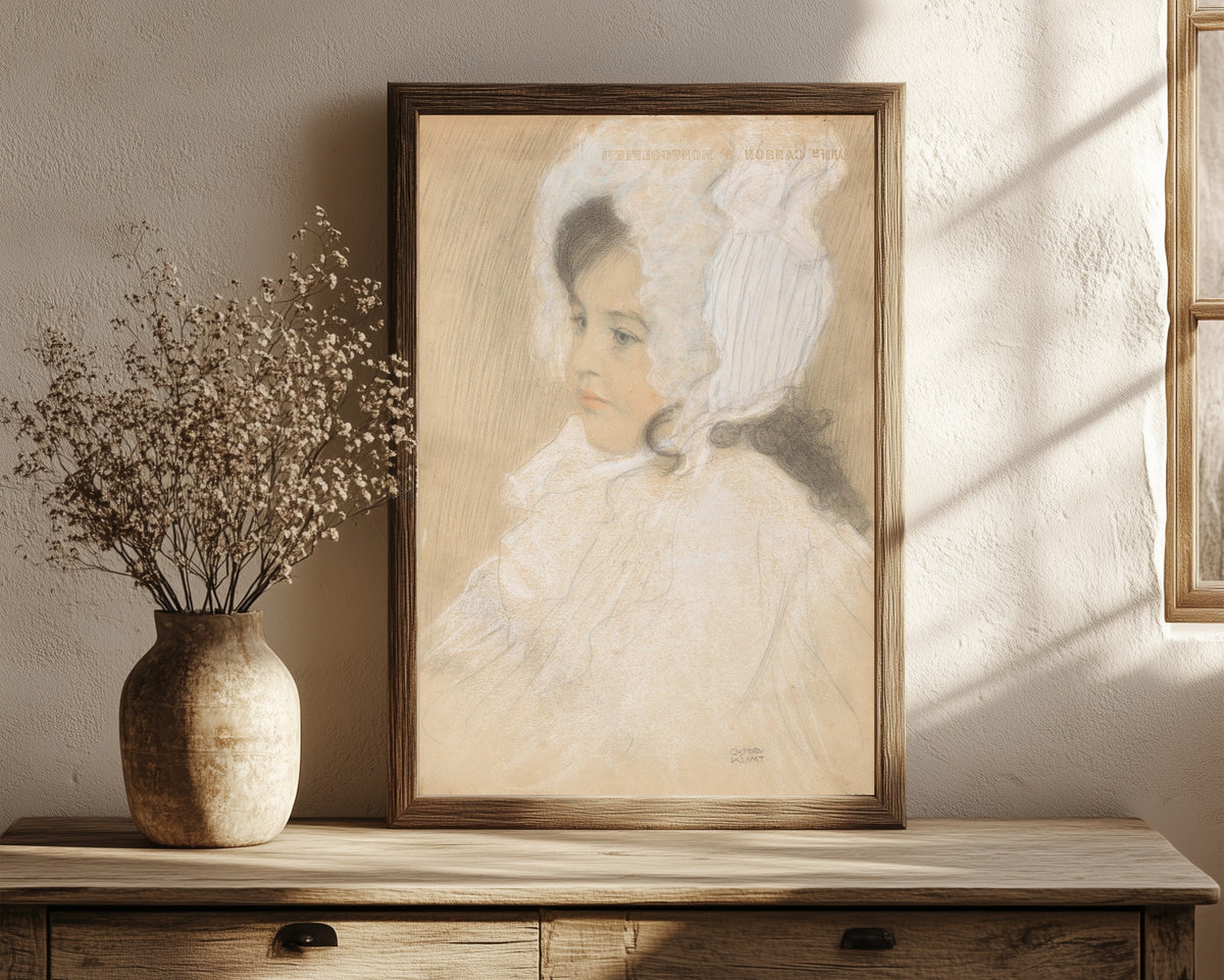 Framed art print of Portrait of a Child (Marie Moll) by Gustav Klimt, in a dark wood frame leaning on a rustic console beside dried flowers
