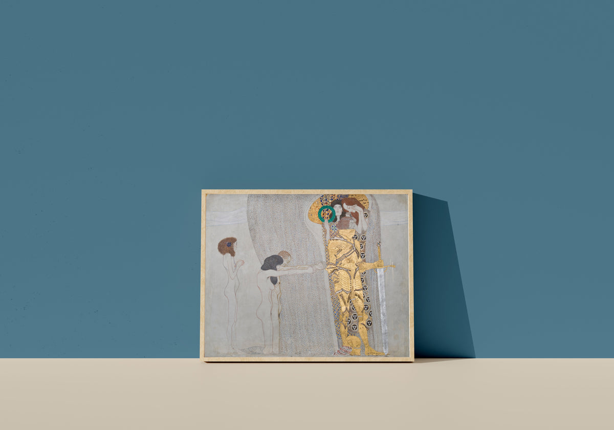 Framed art print of The Suffering of Weak Mankind (Beethoven Frieze) by Gustav Klimt, in a light wood frame leaning on a blue wall