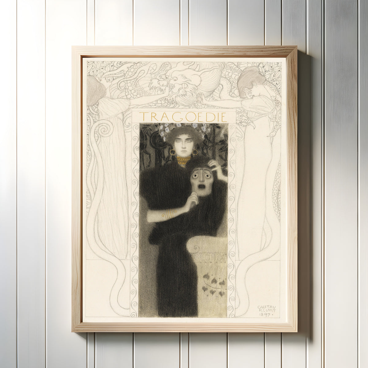 Framed art print of Tragedy (Tragödie) by Gustav Klimt, in a light wood frame on a white panelled wall