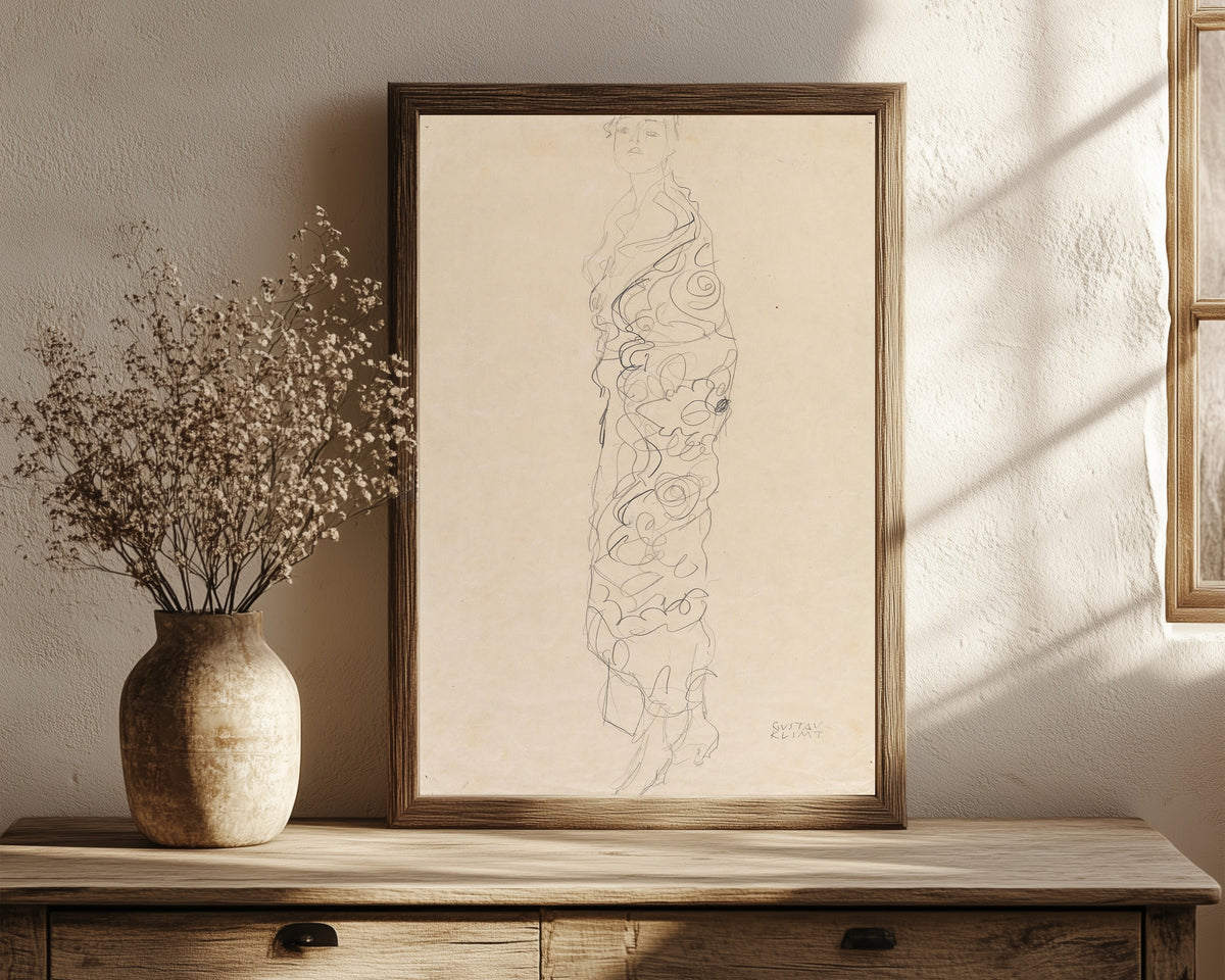 Framed art print of Woman in Kimono by Gustav Klimt, in a dark wood frame leaning on a rustic console beside dried flowers