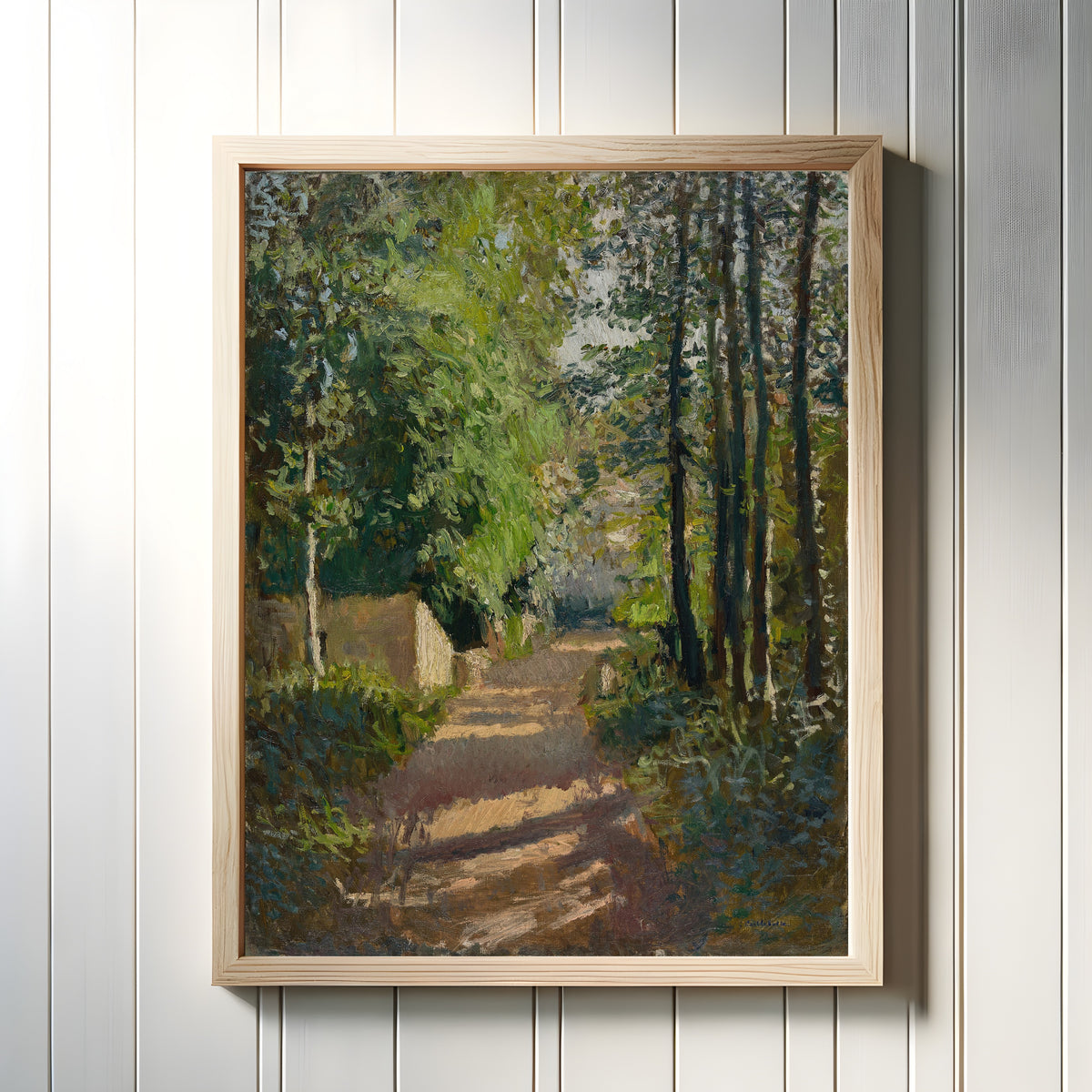 Framed art print of Allée sous-bois, en Normandie by Gustave Caillebotte, in a light wood frame on a white panelled wall