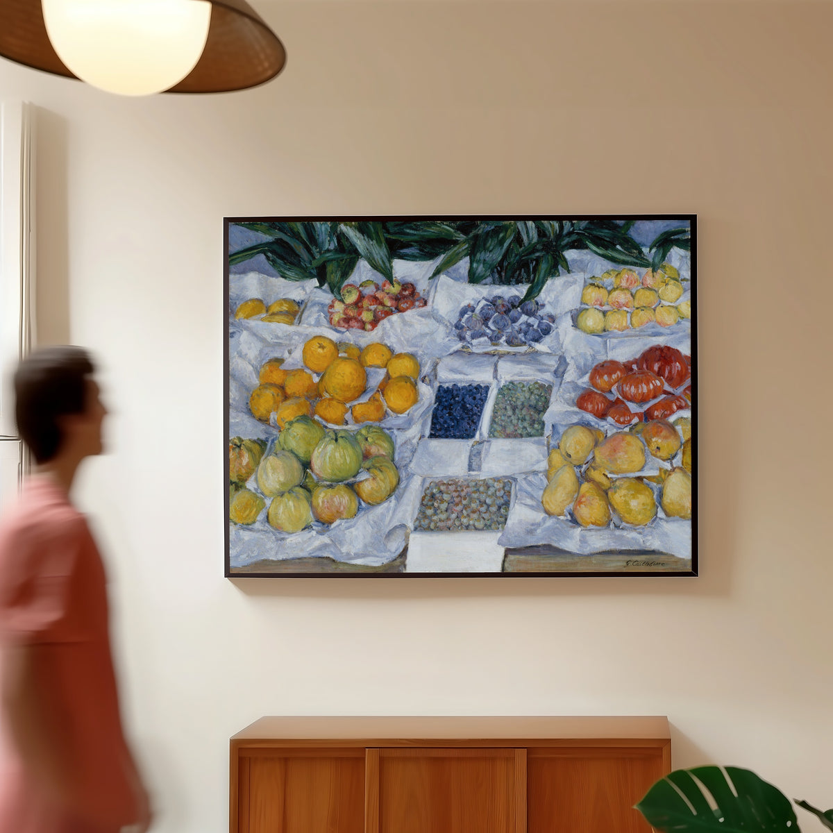 Framed art print of Fruit Displayed on a Stand by Gustave Caillebotte, in a slim black frame on a warm wall in a sunlit room