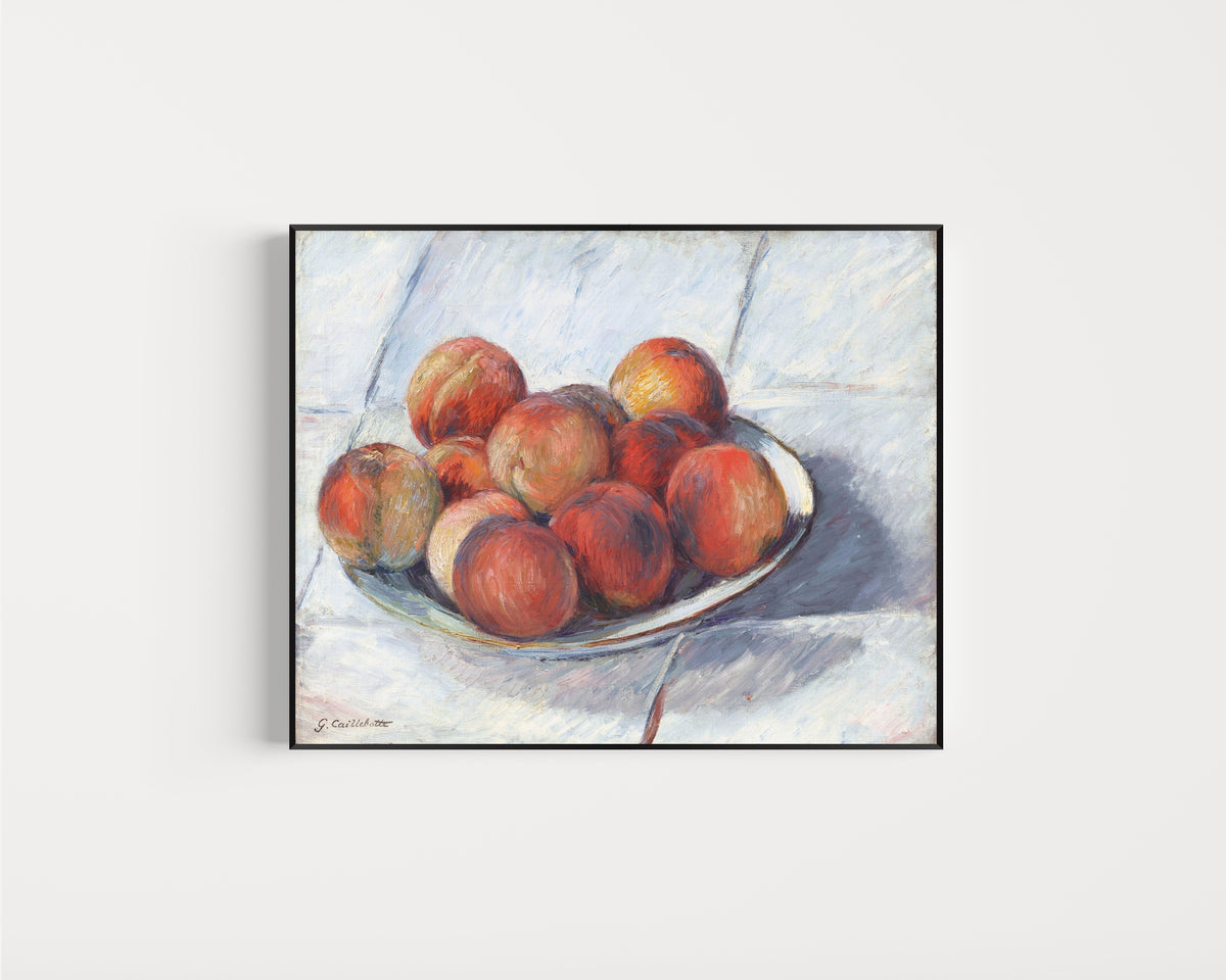 Framed art print of L’Assiette de pêches (Plate of Peaches) by Gustave Caillebotte, in a slim black frame on a plain white wall