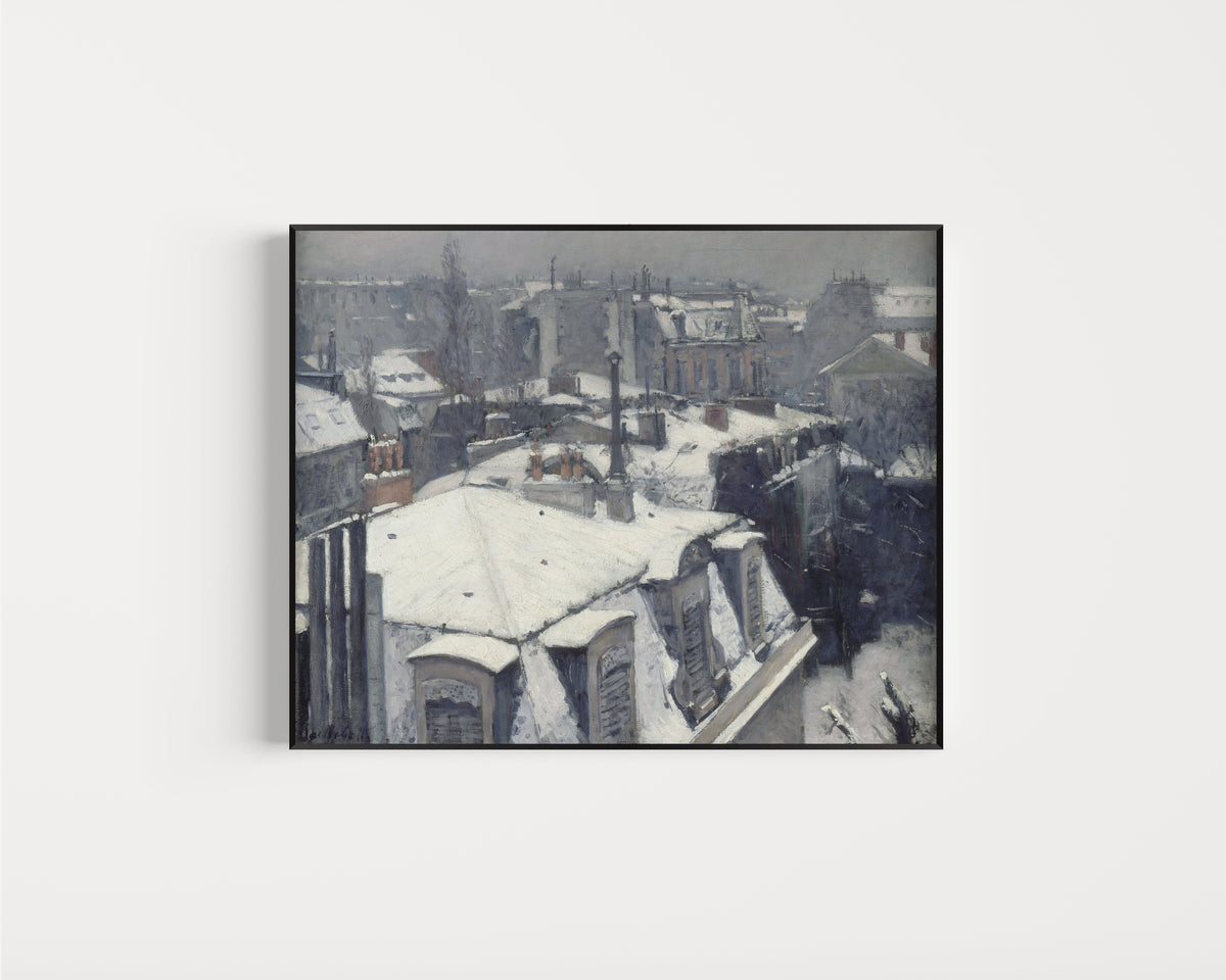 Framed art print of Rooftops in the Snow (Snow Effect) by Gustave Caillebotte, in a slim black frame on a plain white wall