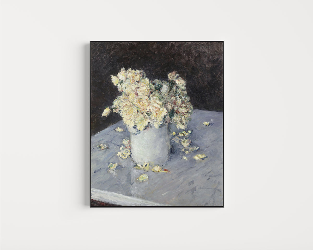 Framed art print of Yellow Roses in a Vase by Gustave Caillebotte, in a slim black frame on a plain white wall