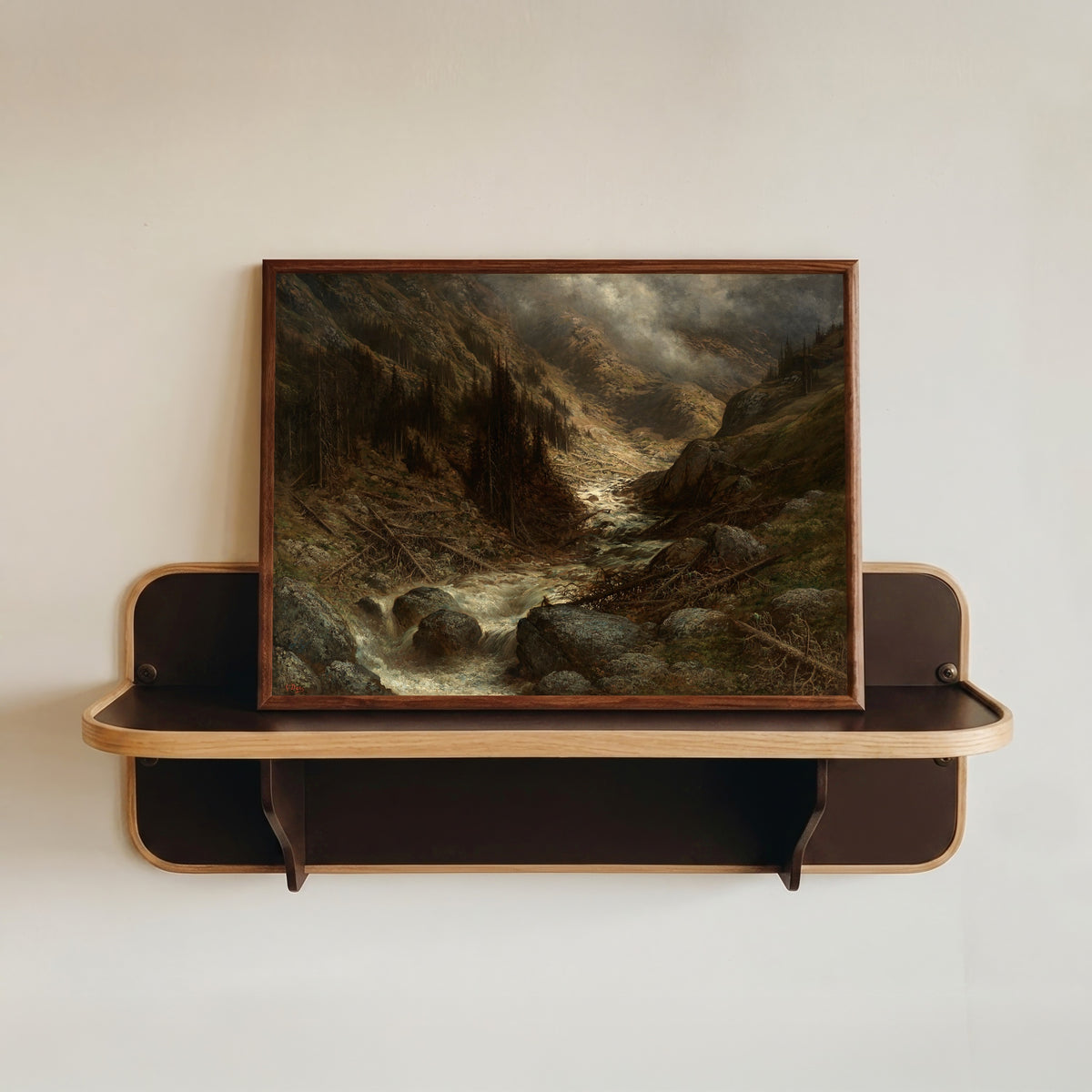 Framed art print of A Torrent in the Engadine by Gustave Doré, in a dark wood frame resting on a wall shelf
