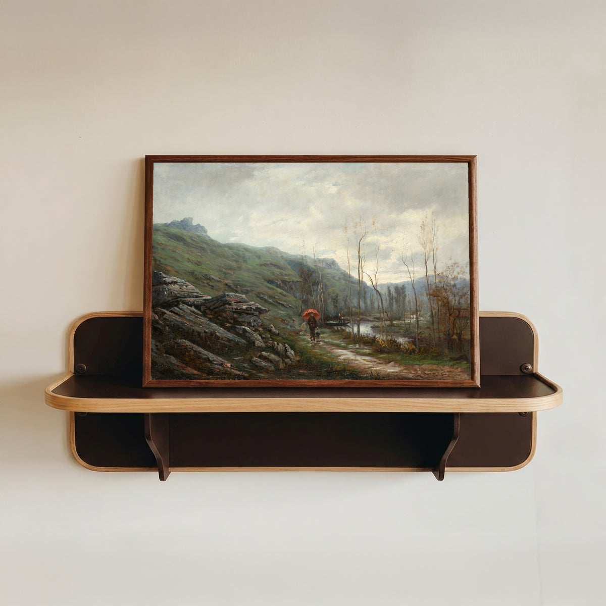 Framed art print of April in the Engadine by Gustave Doré, in a dark wood frame resting on a wall shelf