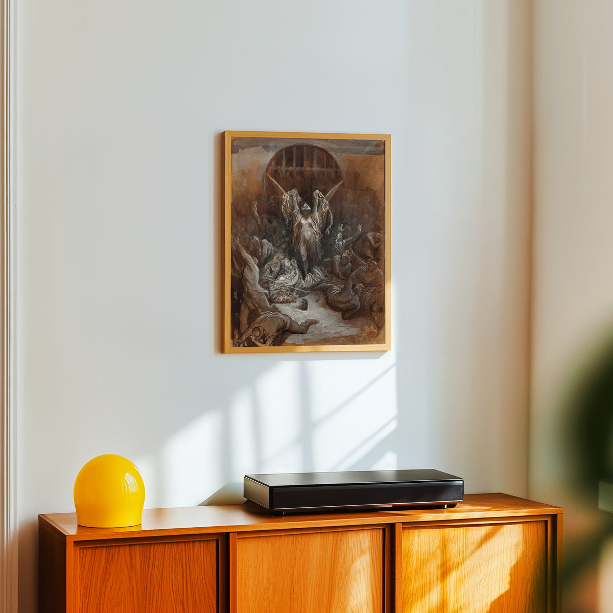 Framed art print of Liberty by Gustave Doré, in a light wood frame on a white wall above an orange sideboard