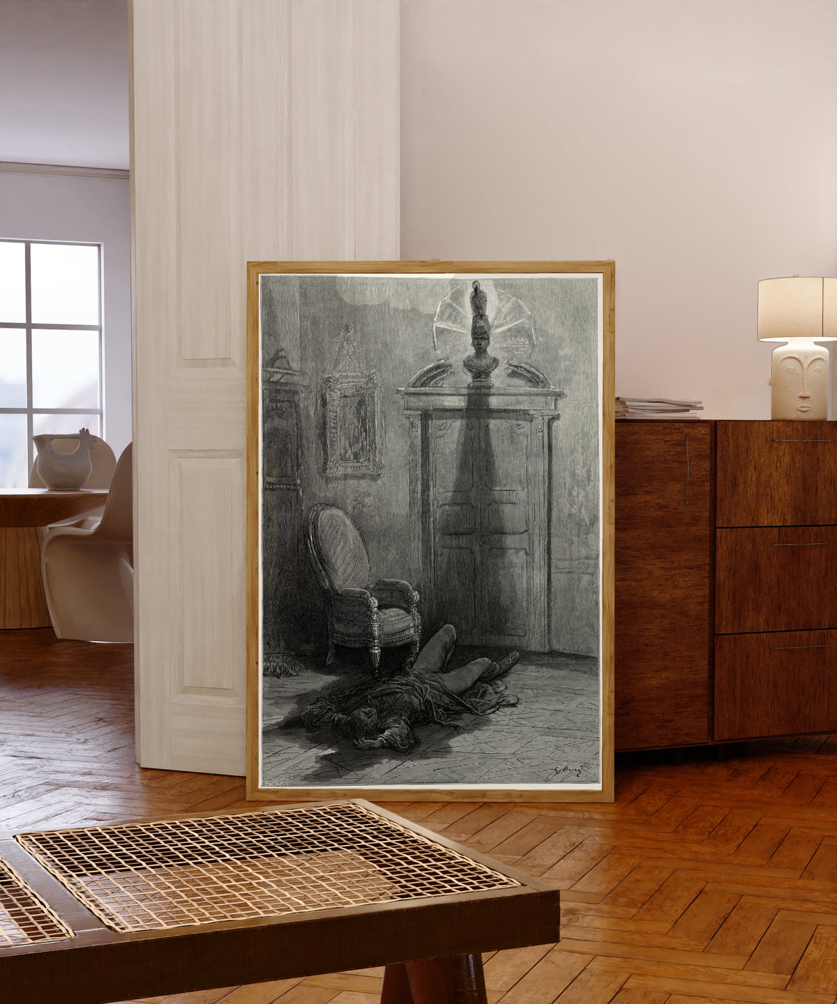 Framed art print of nevermore! by Gustave Doré, in a light wood frame leaning in a warm room with a parquet floor