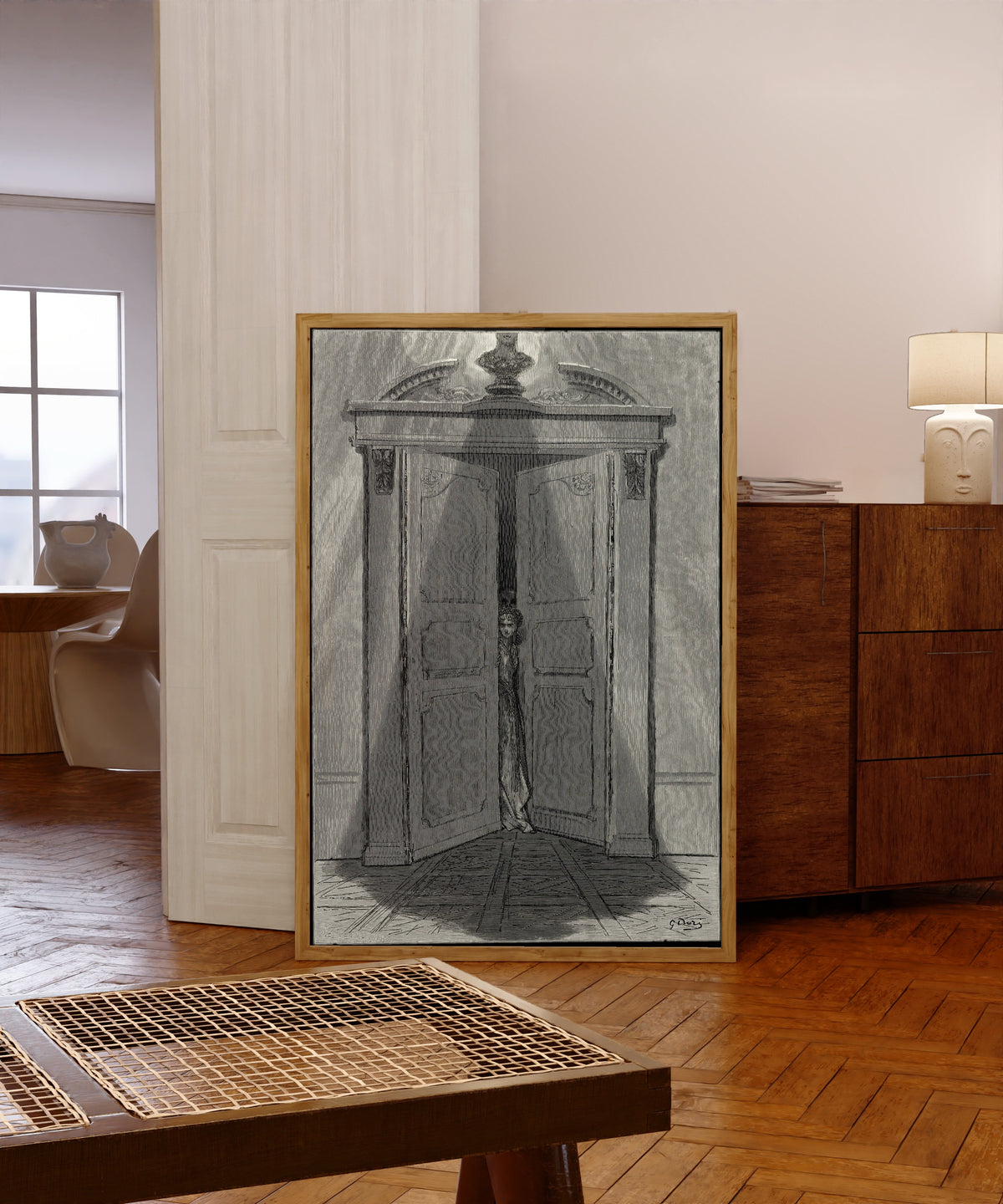 Framed art print of Some late visiter entreating entrance at my chamber door by Gustave Doré, in a light wood frame leaning in a warm room with a parquet floor