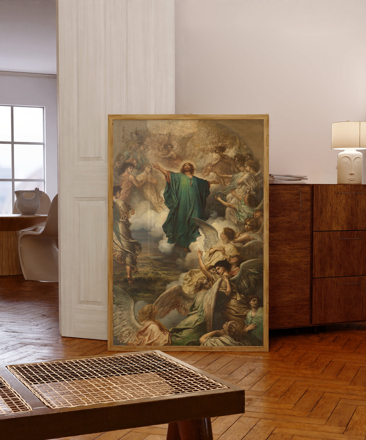 Framed art print of The Ascension by Gustave Doré, in a light wood frame leaning in a warm room with a parquet floor