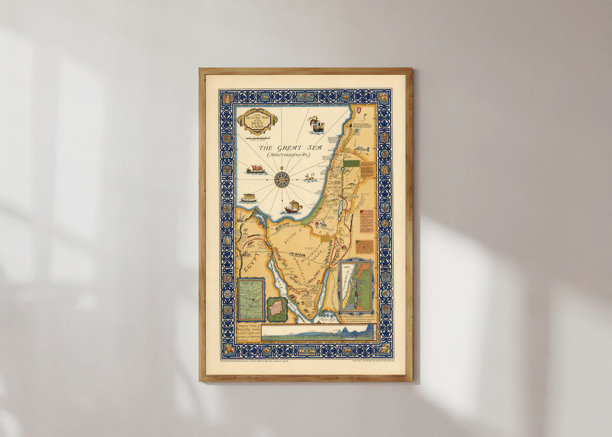 Framed art print of The Picture Map of the Holy Land by Harold Haven Brown, in a light wood frame on a sunlit white wall