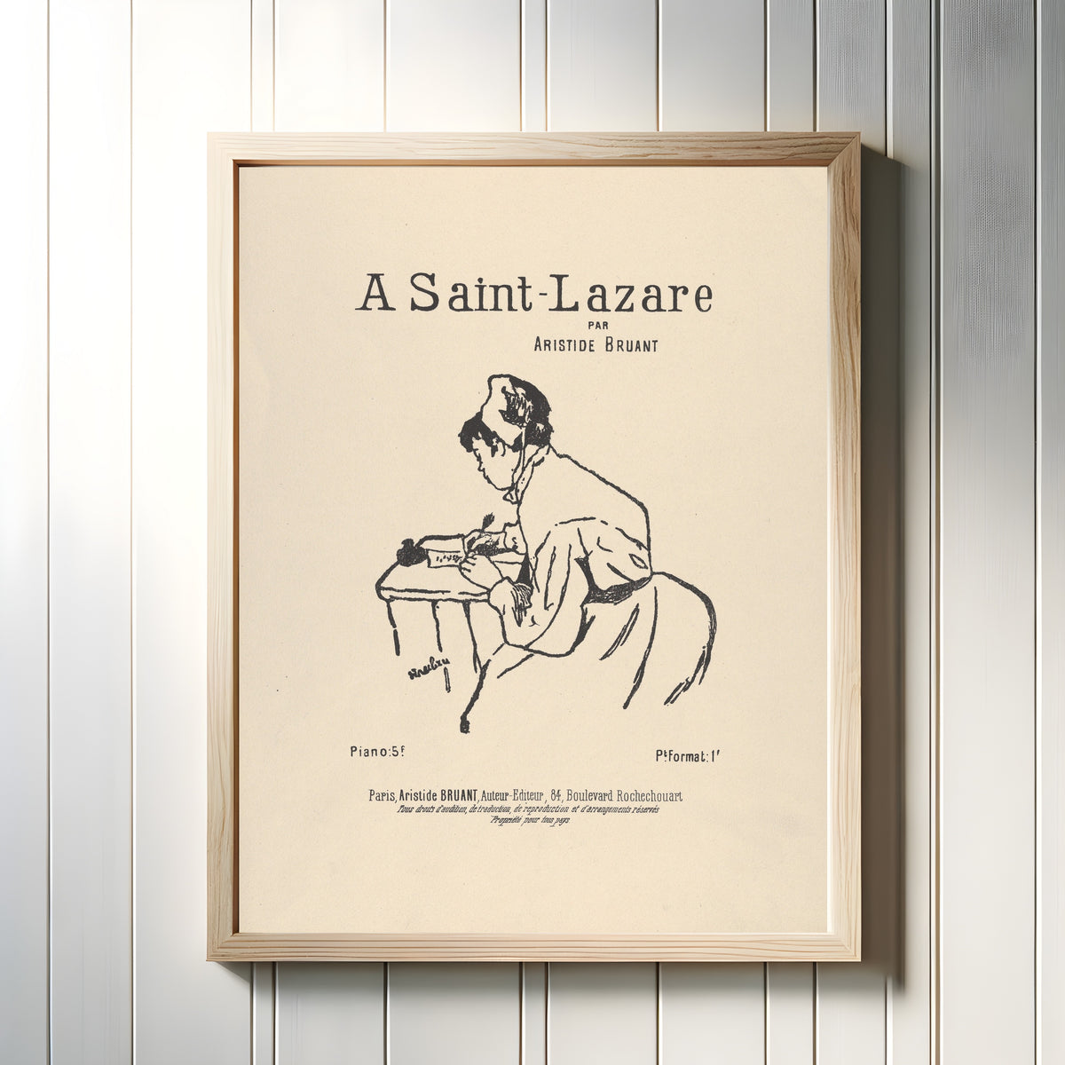 Framed art print of A Saint-Lazare par Aristide Bruant by Henri de Toulouse-Lautrec, in a light wood frame on a white panelled wall