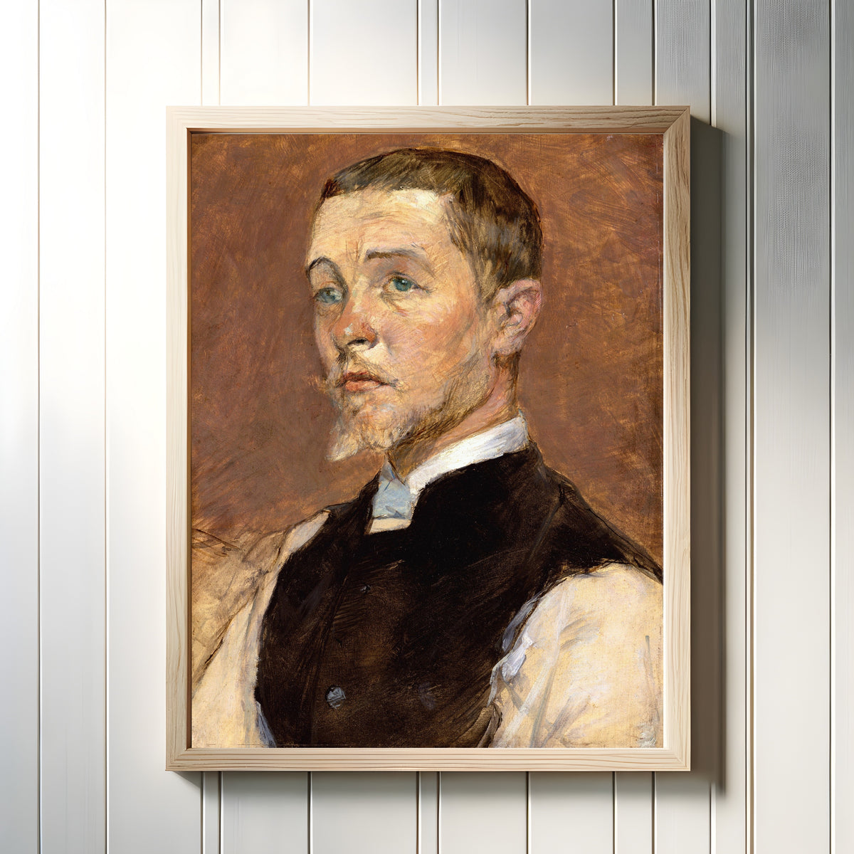 Framed art print of Albert (René) Grenier by Henri de Toulouse-Lautrec, in a light wood frame on a white panelled wall