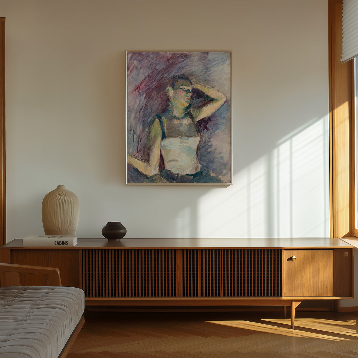 Framed art print of Étude de danseuse by Henri de Toulouse-Lautrec, in a thin light frame on a sunlit wall above a wooden sideboard