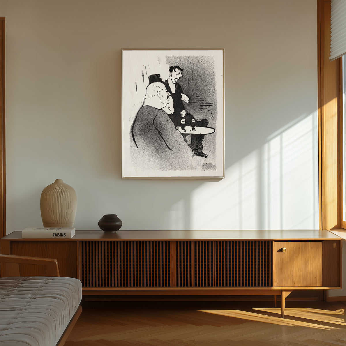 Framed art print of Le Café-Concert: Ducarre aux Ambassadeurs by Henri de Toulouse-Lautrec, in a thin light frame on a sunlit wall above a wooden sideboard