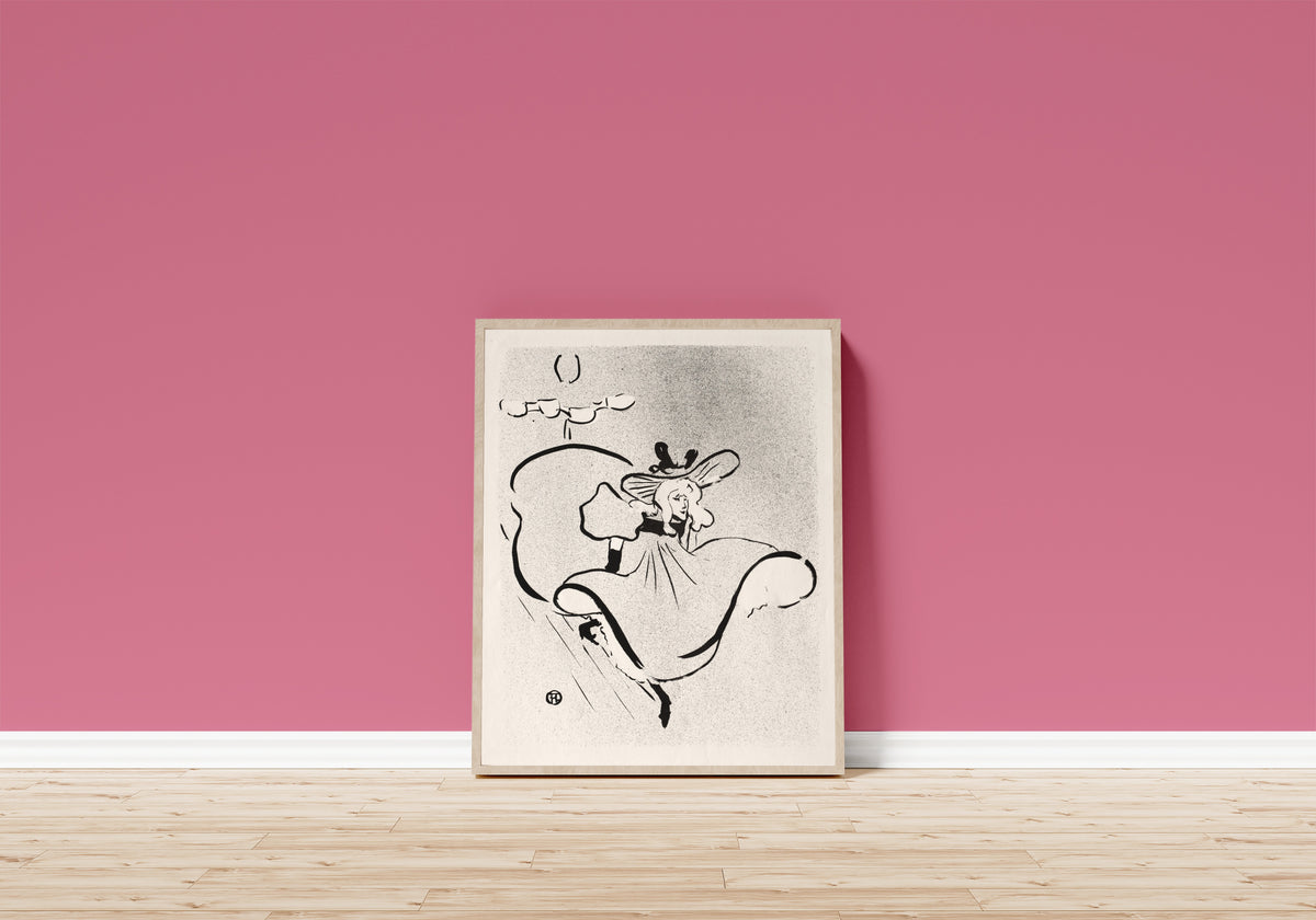 Framed art print of Le Café-Concert: Jane Avril by Henri de Toulouse-Lautrec, in a light wood frame leaning on a pink wall above a wooden floor