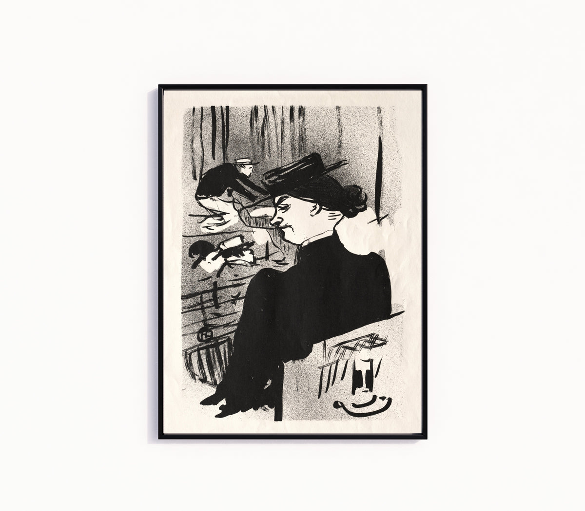 Framed art print of Le Café-Concert: Une Spectatrice by Henri de Toulouse-Lautrec, in a slim black frame on a plain white wall
