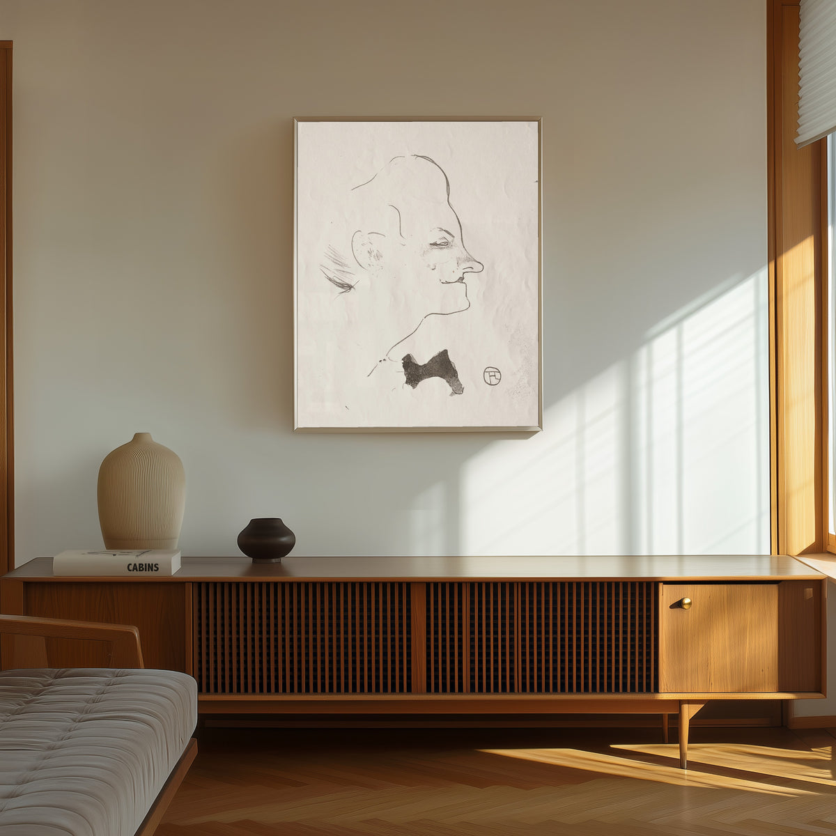 Framed art print of Le Café-Concert: Yvette Guilbert by Henri de Toulouse-Lautrec, in a thin light frame on a sunlit wall above a wooden sideboard