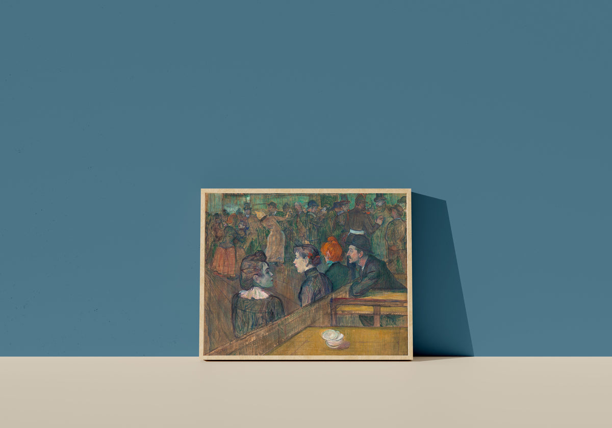Framed art print of Moulin de la Galette by Henri de Toulouse-Lautrec, in a light wood frame leaning on a blue wall