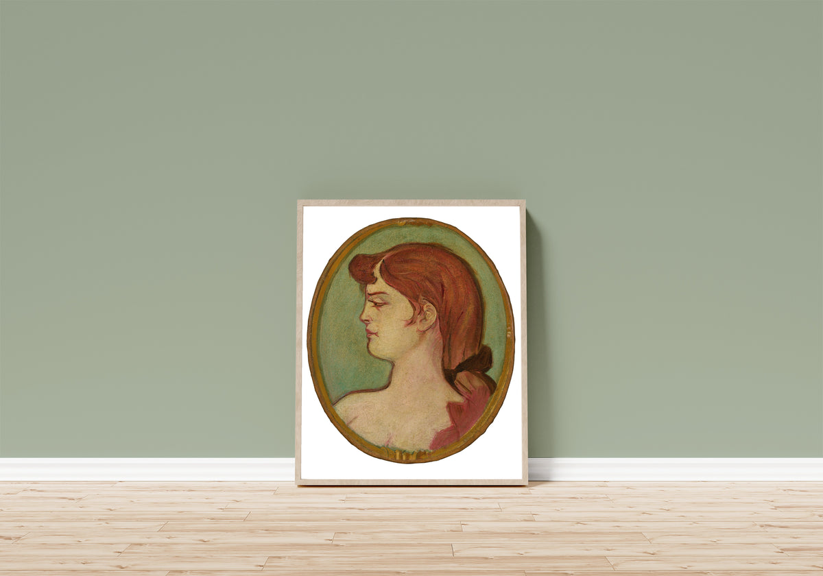 Framed art print of Portrait of a Woman of the House on… by Henri de Toulouse-Lautrec, in a light wood frame leaning on a sage green wall above a wooden floor
