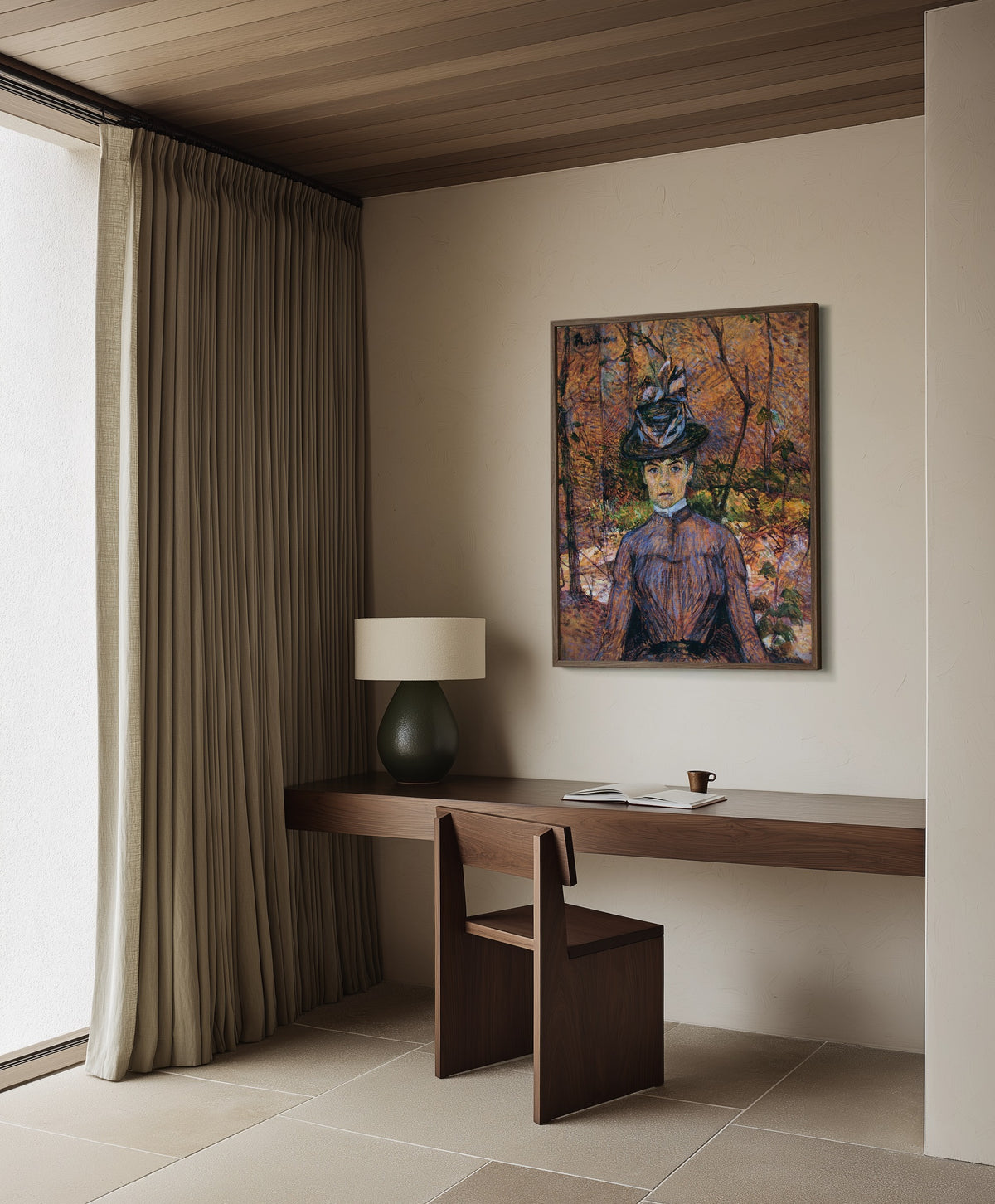 Framed art print of Portrait of Suzanne Valadon by Henri de Toulouse-Lautrec, in a dark wood frame on a plaster wall above a walnut desk