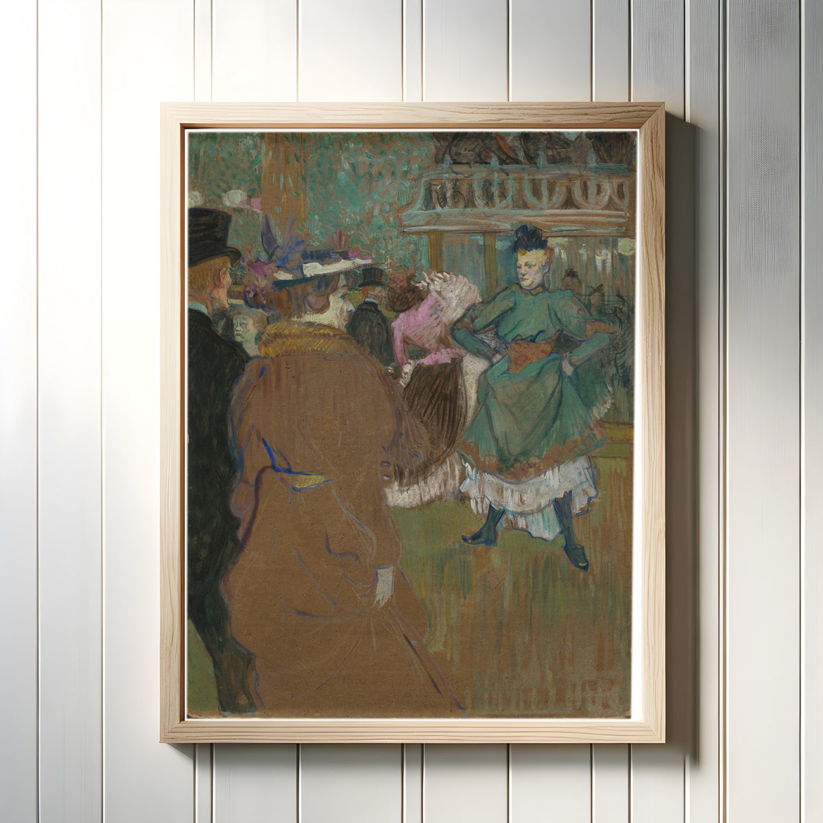 Framed art print of Quadrille at the Moulin Rouge by Henri de Toulouse-Lautrec, in a light wood frame on a white panelled wall