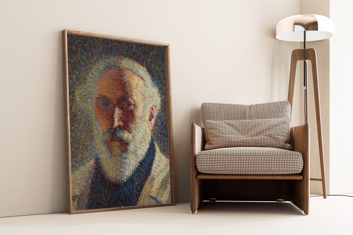 Framed art print of Autoportrait à la barbe blanche by Henri Martin, leaning against a wall beside an armchair and a floor lamp