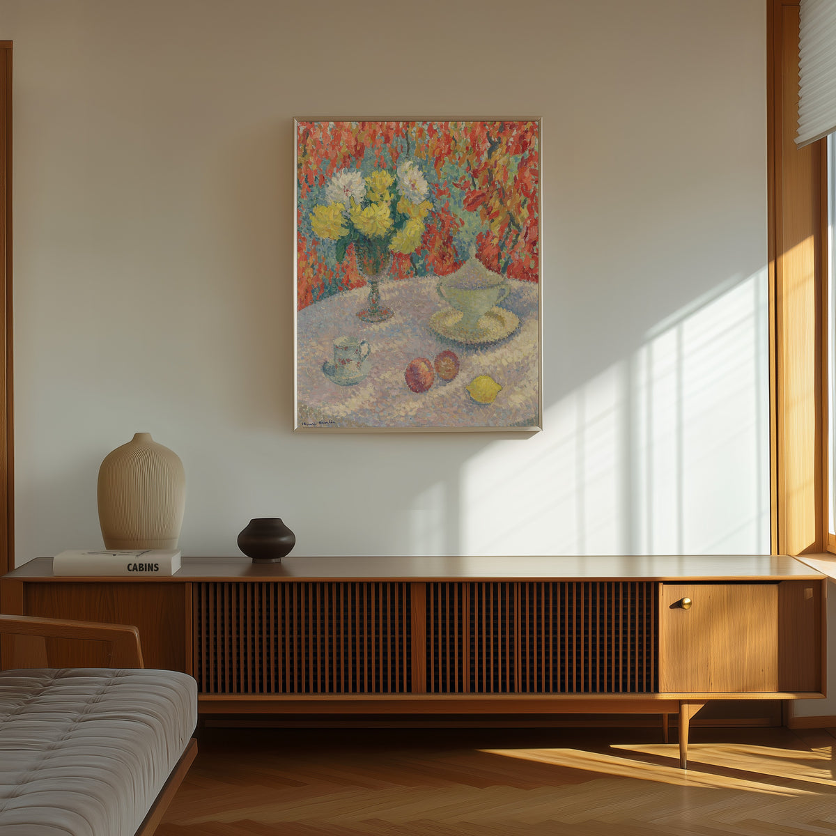 Framed art print of Dahlias au soleil by Henri Martin, in a thin light frame on a sunlit wall above a wooden sideboard
