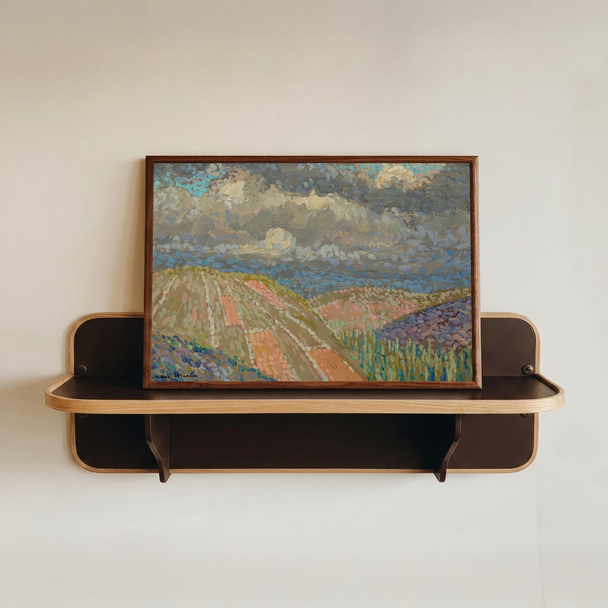 Framed art print of Étude de Causse du Lot by Henri Martin, in a dark wood frame resting on a wall shelf