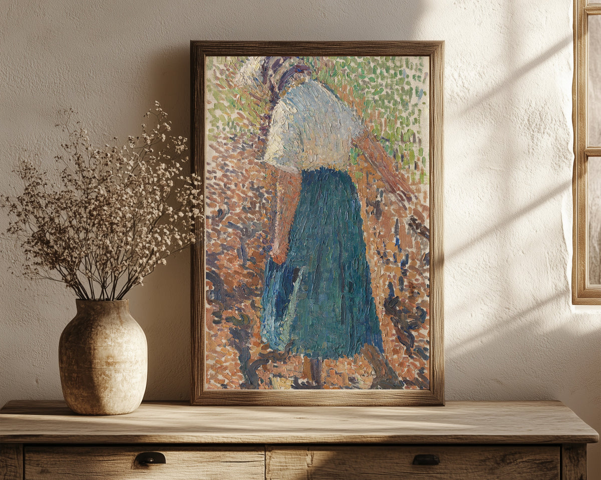 Framed art print of Jeune femme dans les vignes by Henri Martin, in a dark wood frame leaning on a rustic console beside dried flowers