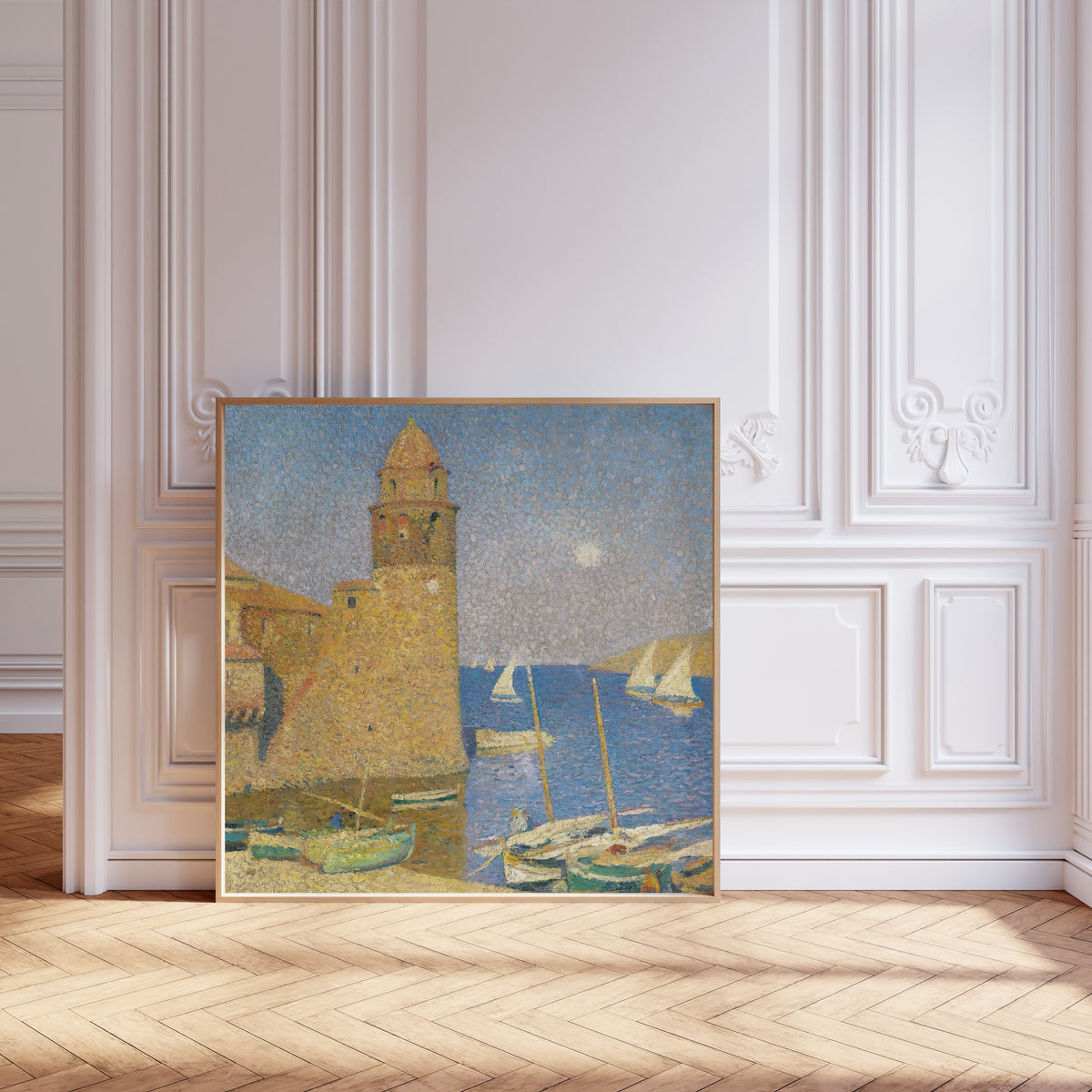 Framed art print of La Tour de Collioure, lever de lune by Henri Martin, leaning against pale pink panelling on a herringbone floor