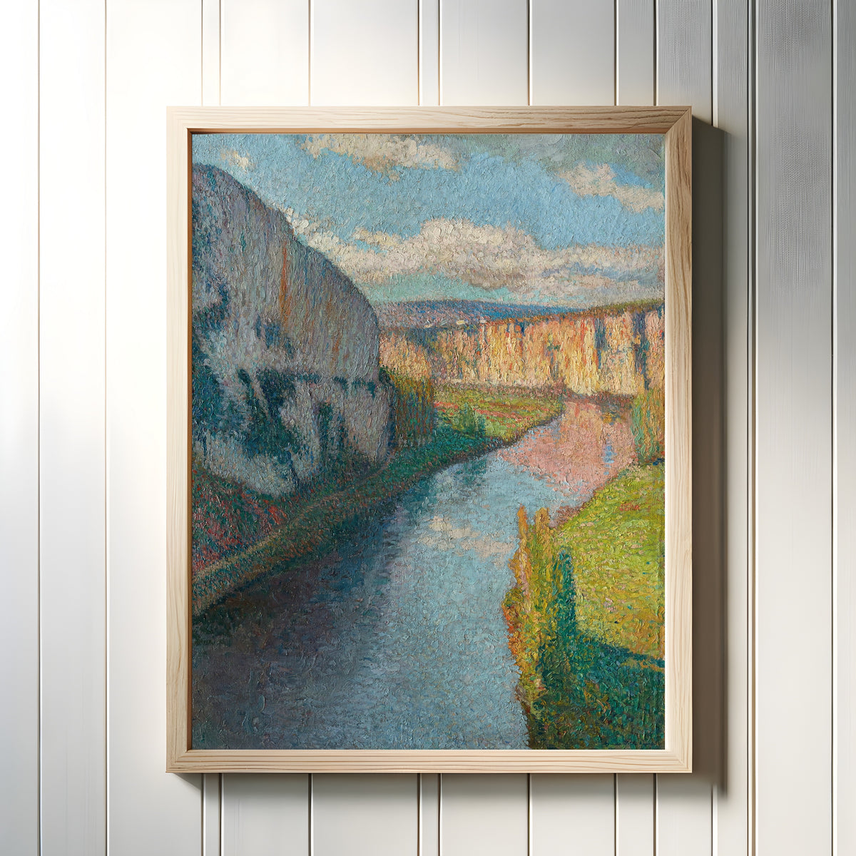 Framed art print of La Vallée du Lot, près de Saint-Cirq-Lapopie (Clouds over the Cliffs) by Henri Martin, in a light wood frame on a white panelled wall