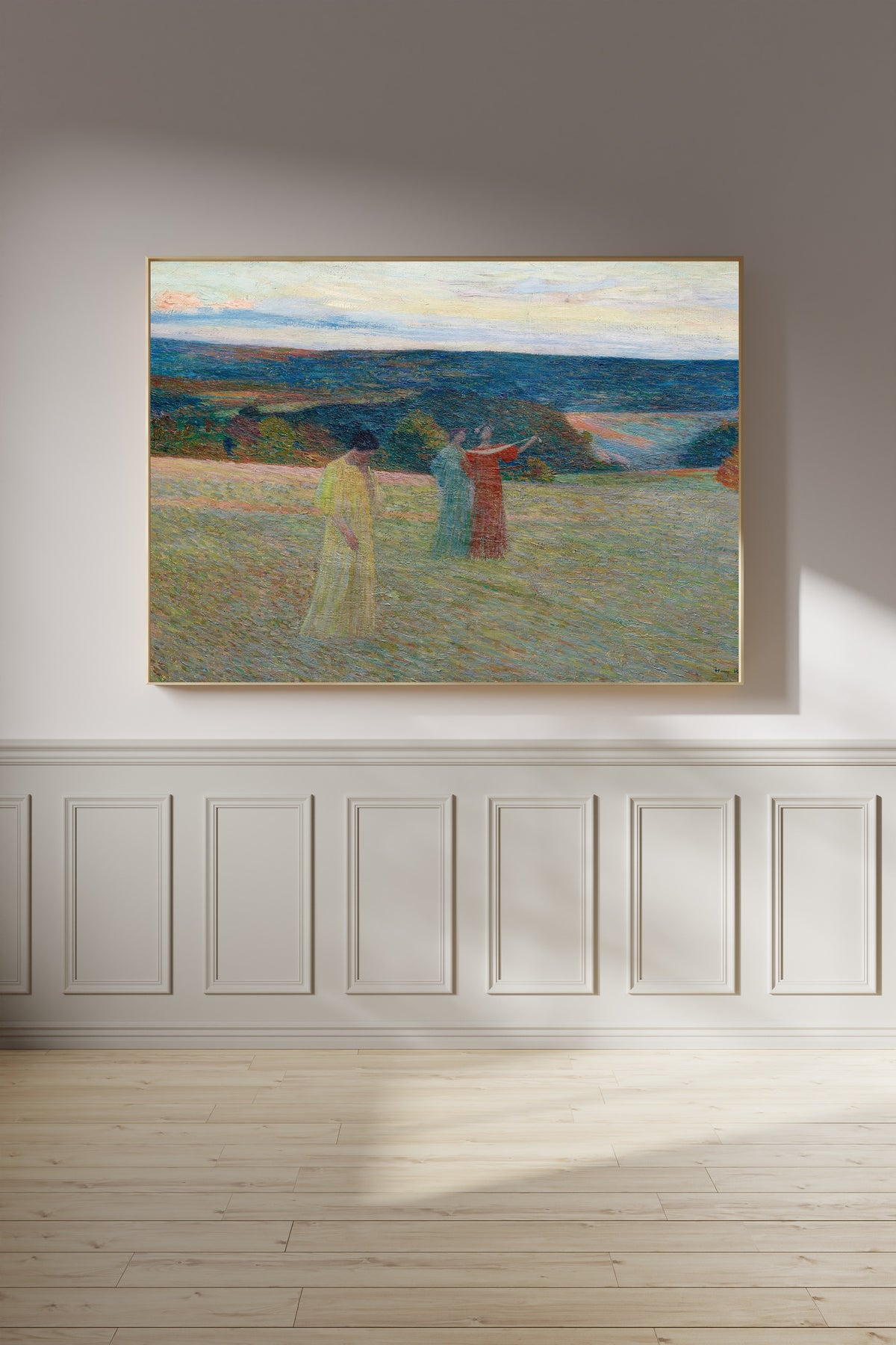 Framed art print of Les Trois Muses by Henri Martin, on a panelled wall in afternoon light