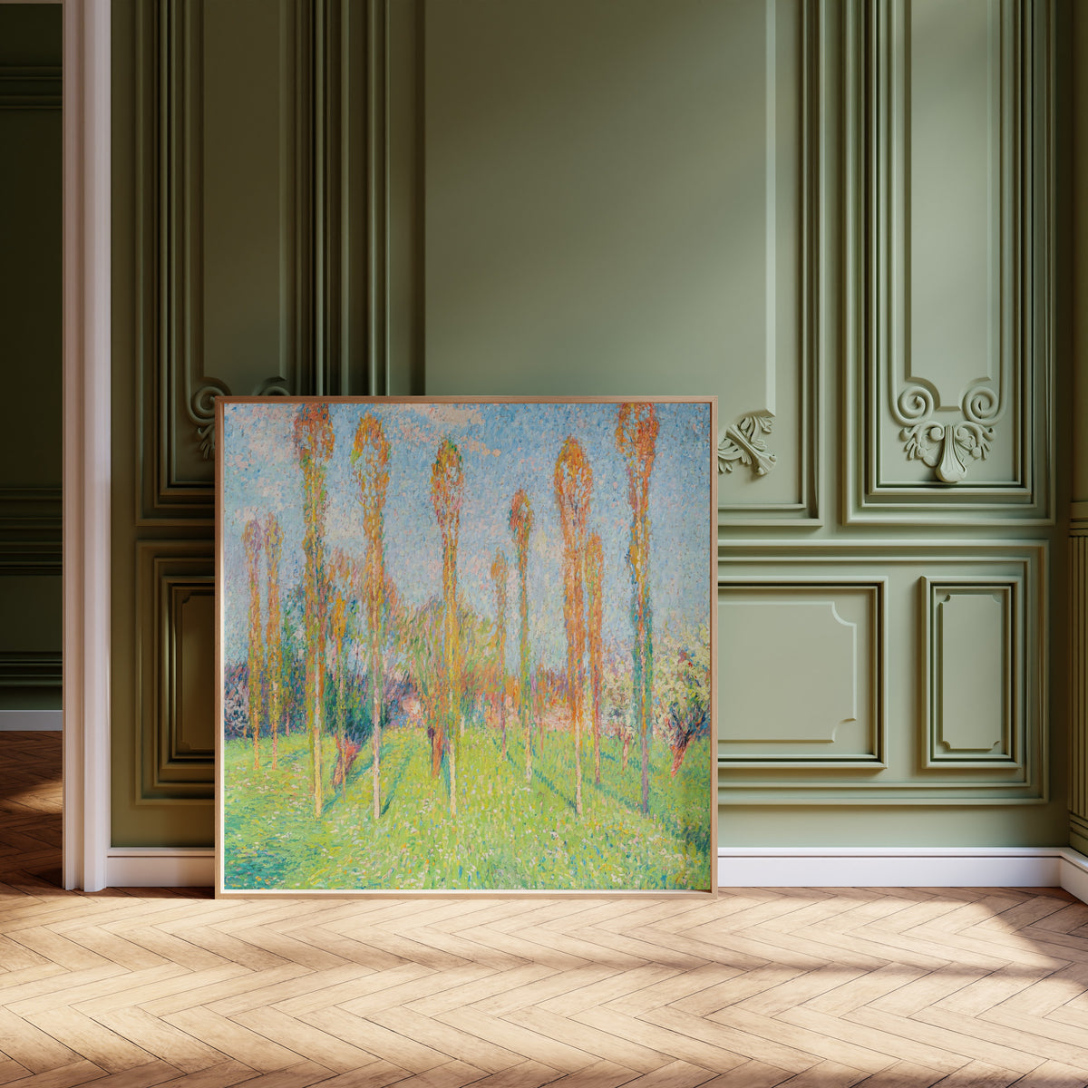 Framed art print of Prairie ensoleillée aux peupliers by Henri Martin, leaning against olive-green panelling on a herringbone floor