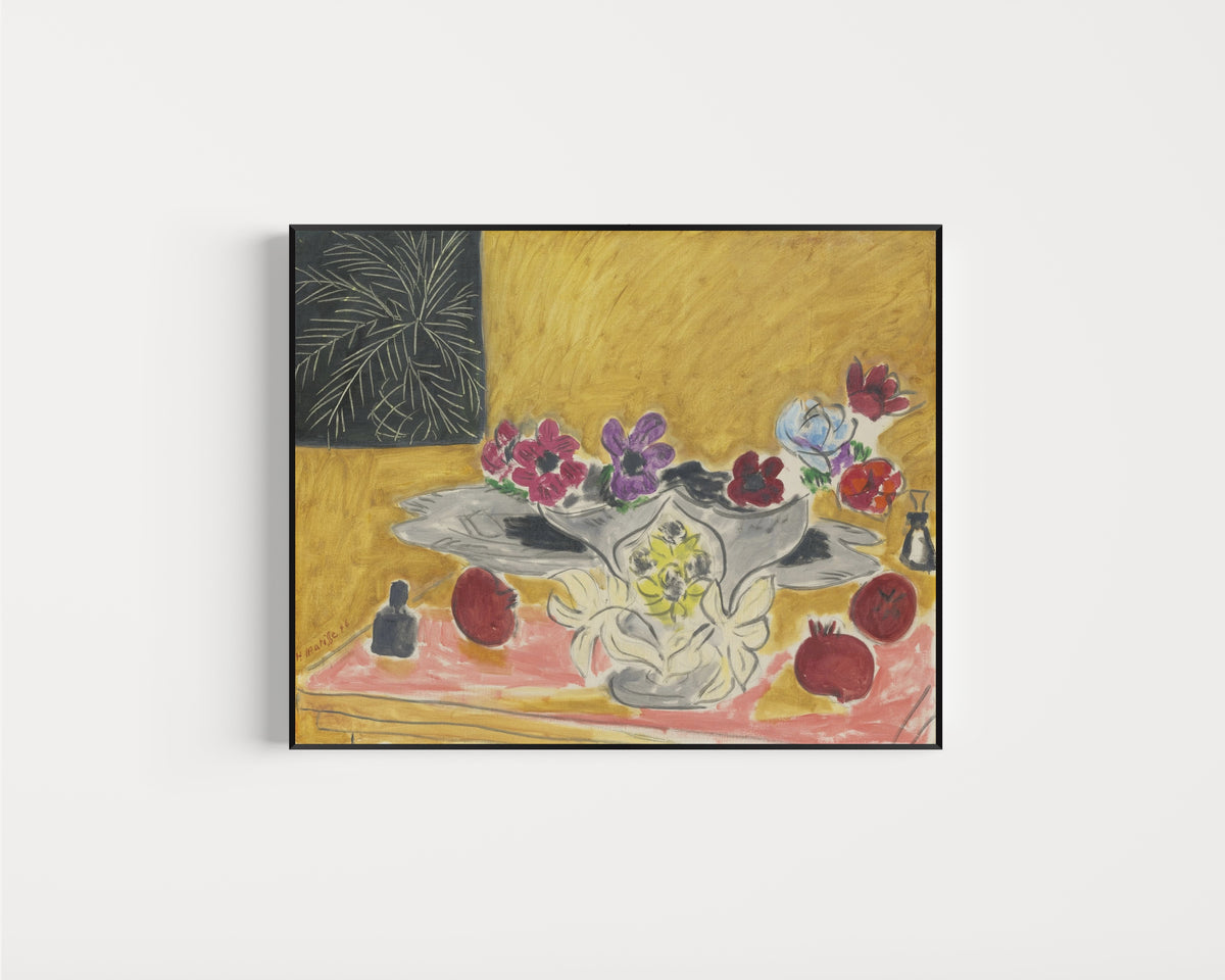 Framed art print of Anemones and Pomegranates by Henri Matisse, in a slim black frame on a plain white wall