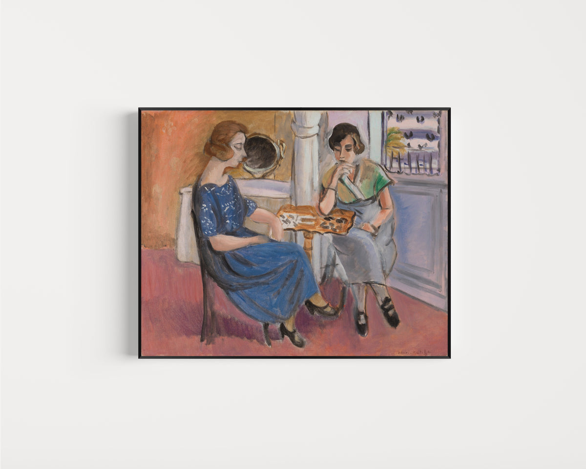 Framed art print of Domino Players by Henri Matisse, in a slim black frame on a plain white wall