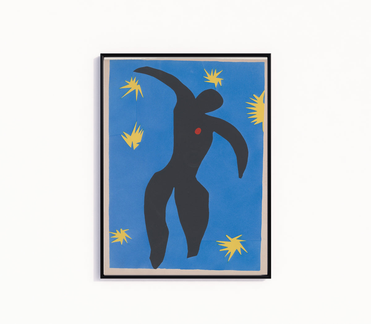 Framed art print of Icarus by Henri Matisse, in a slim black frame on a plain white wall