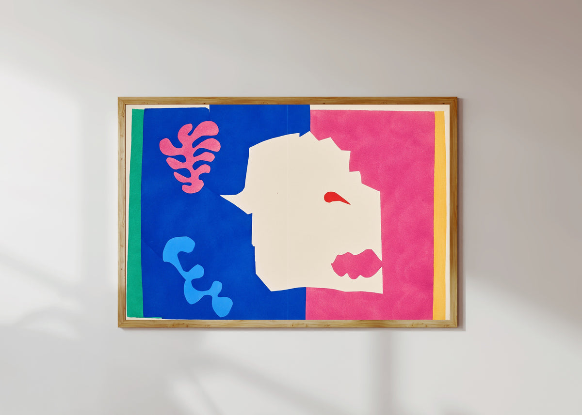 Framed art print of The Wolf by Henri Matisse, in a light wood frame on a sunlit white wall