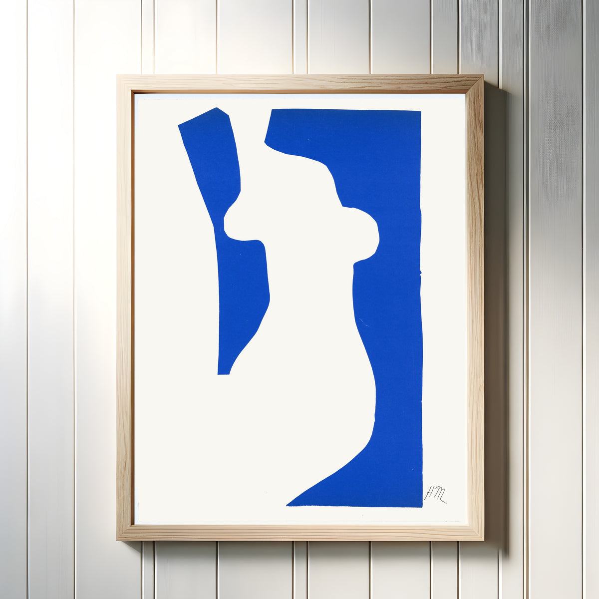 Framed art print of Venus by Henri Matisse, in a light wood frame on a white panelled wall