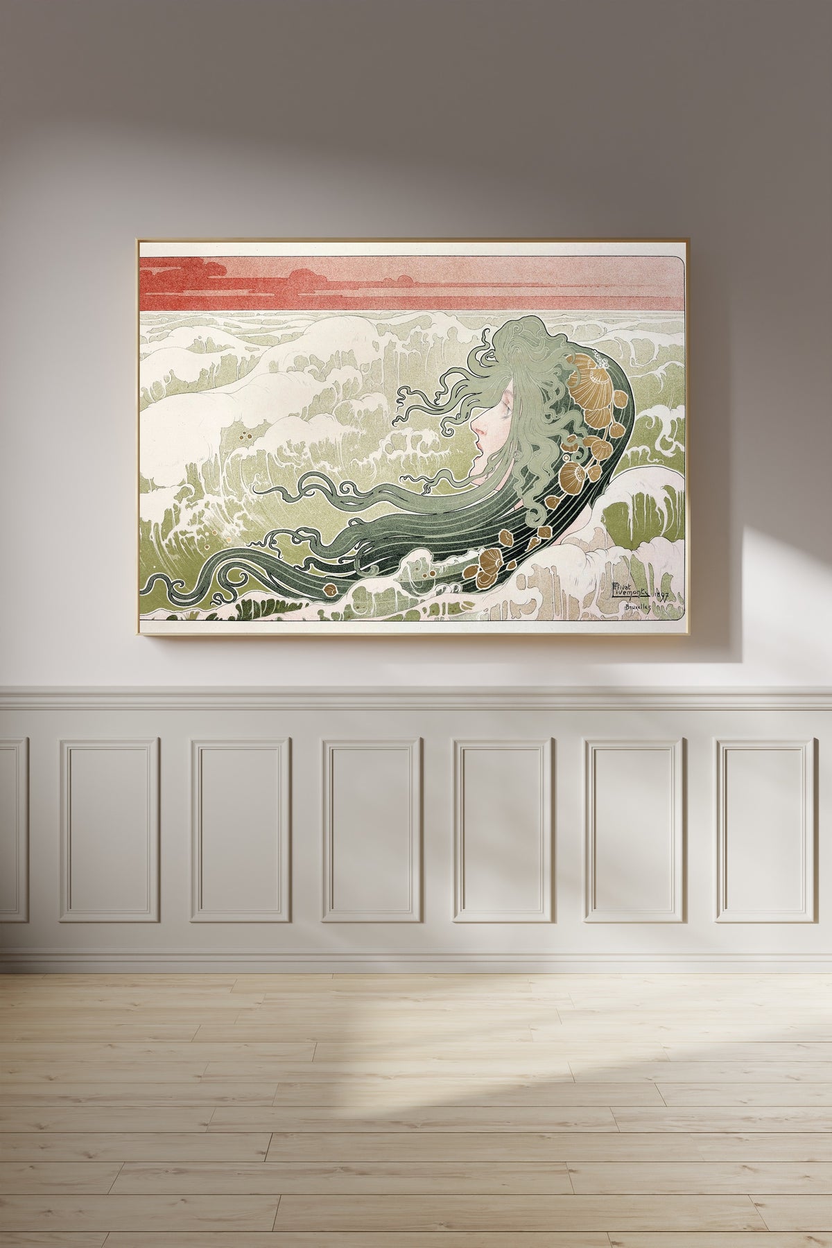 Framed art print of La Vague (The Wave) by Henri Privat-Livemont, on a panelled wall in afternoon light