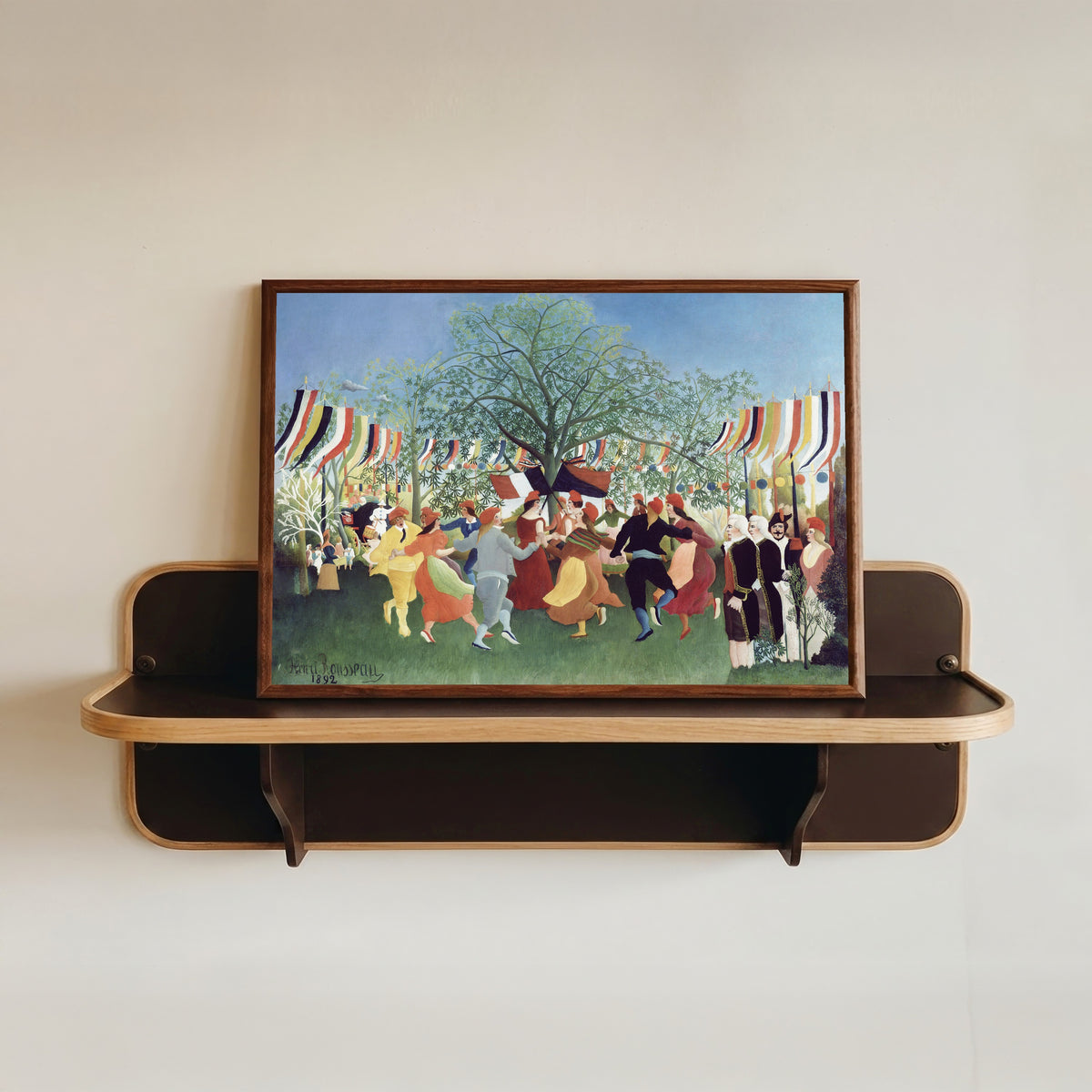 Framed art print of A Centennial of Independence by Henri Rousseau, in a dark wood frame resting on a wall shelf