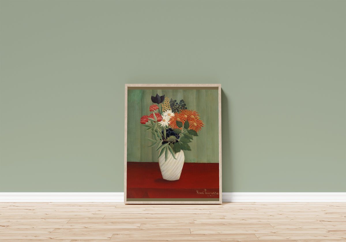 Framed art print of Bouquet of Flowers with China Asters and Tokyos by Henri Rousseau, in a light wood frame leaning on a sage green wall above a wooden floor