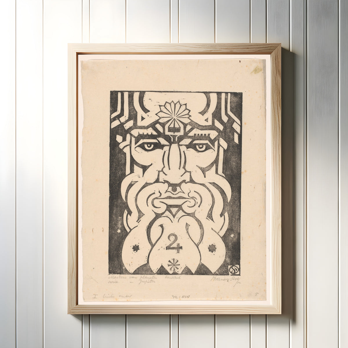 Framed art print of Jupiter by Henri van der Stok, in a light wood frame on a white panelled wall