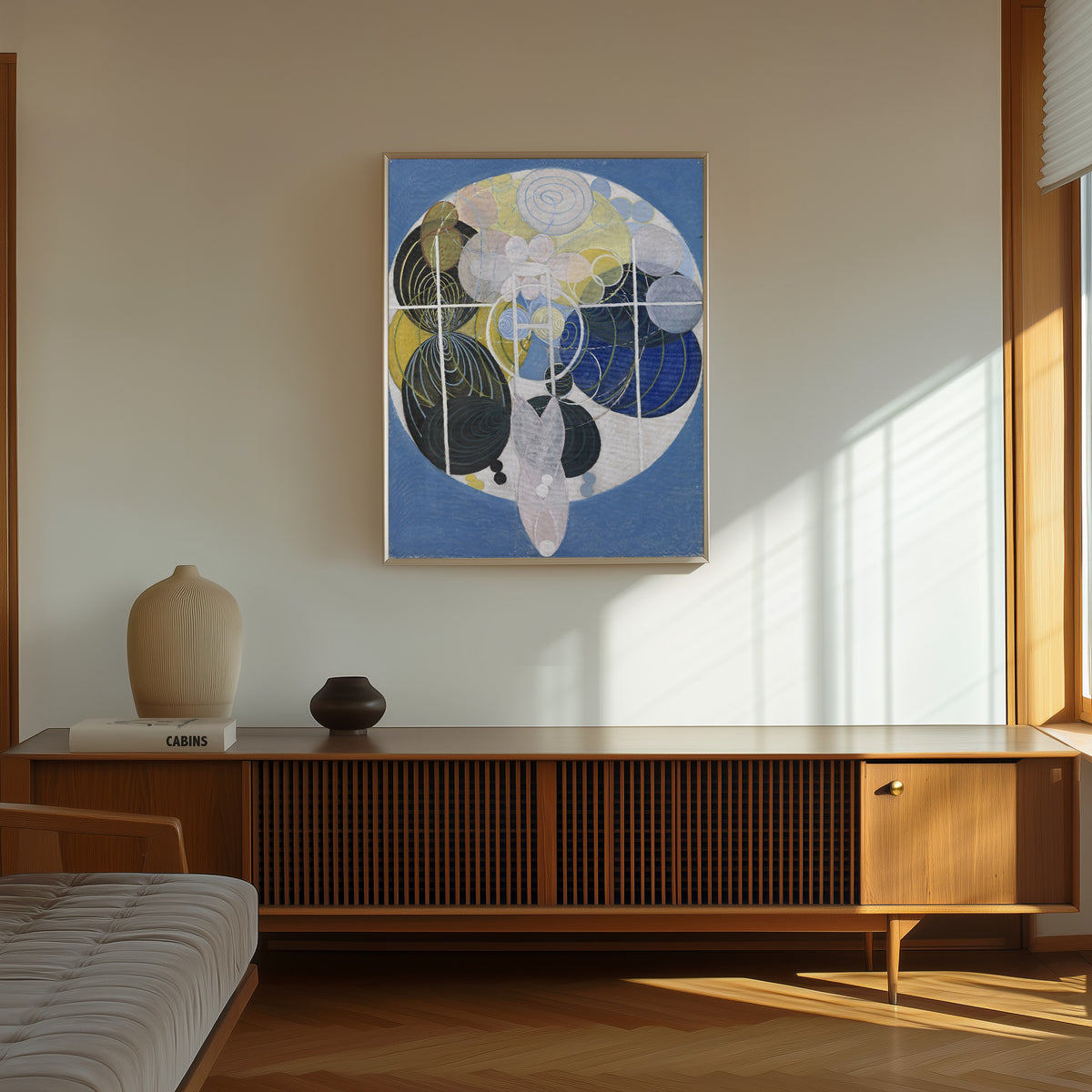 Framed art print of The Large Figure Paintings, No. 5, Group 3 by Hilma af Klint, in a thin light frame on a sunlit wall above a wooden sideboard