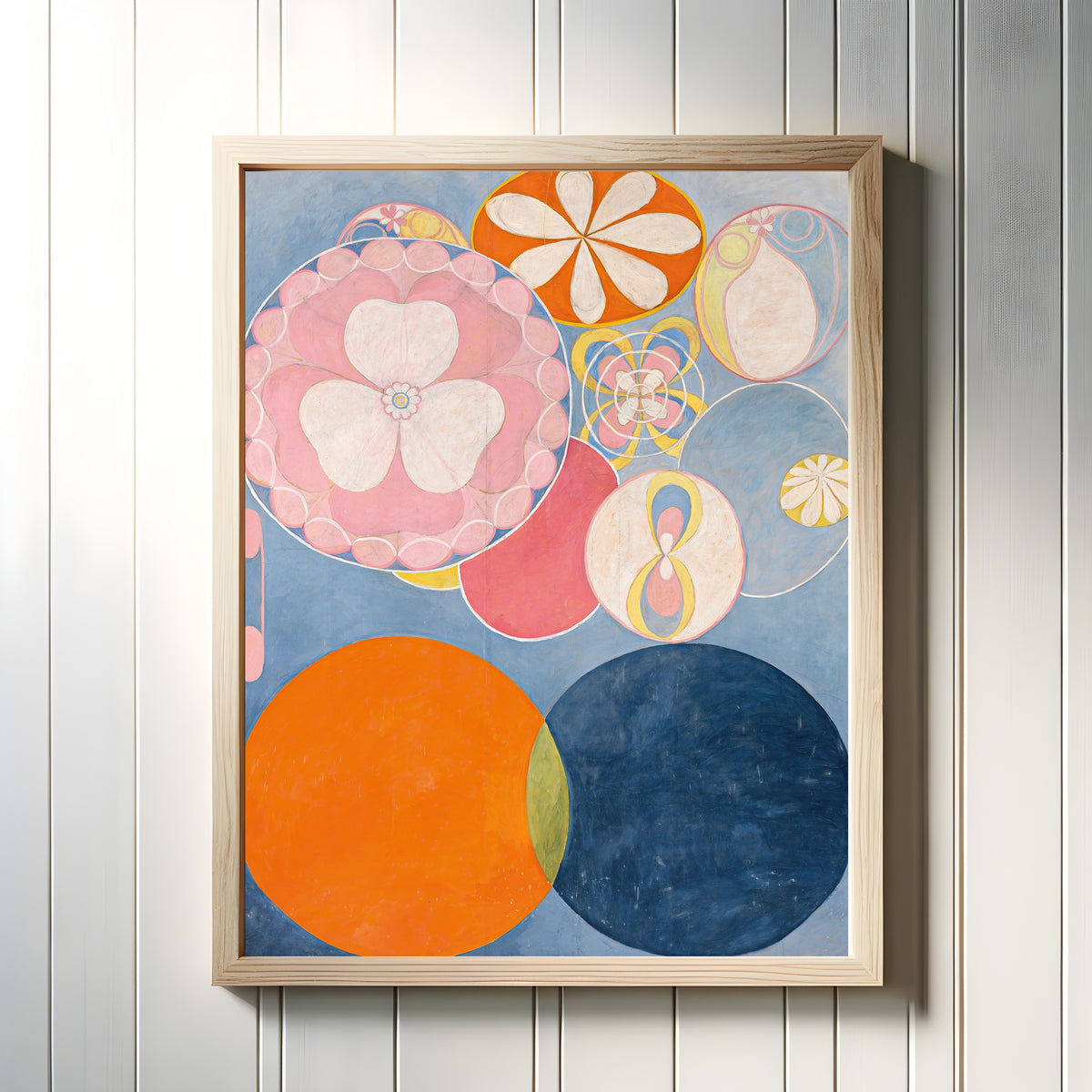 Framed art print of The Ten Largest, No. 2, Childhood by Hilma af Klint, in a light wood frame on a white panelled wall