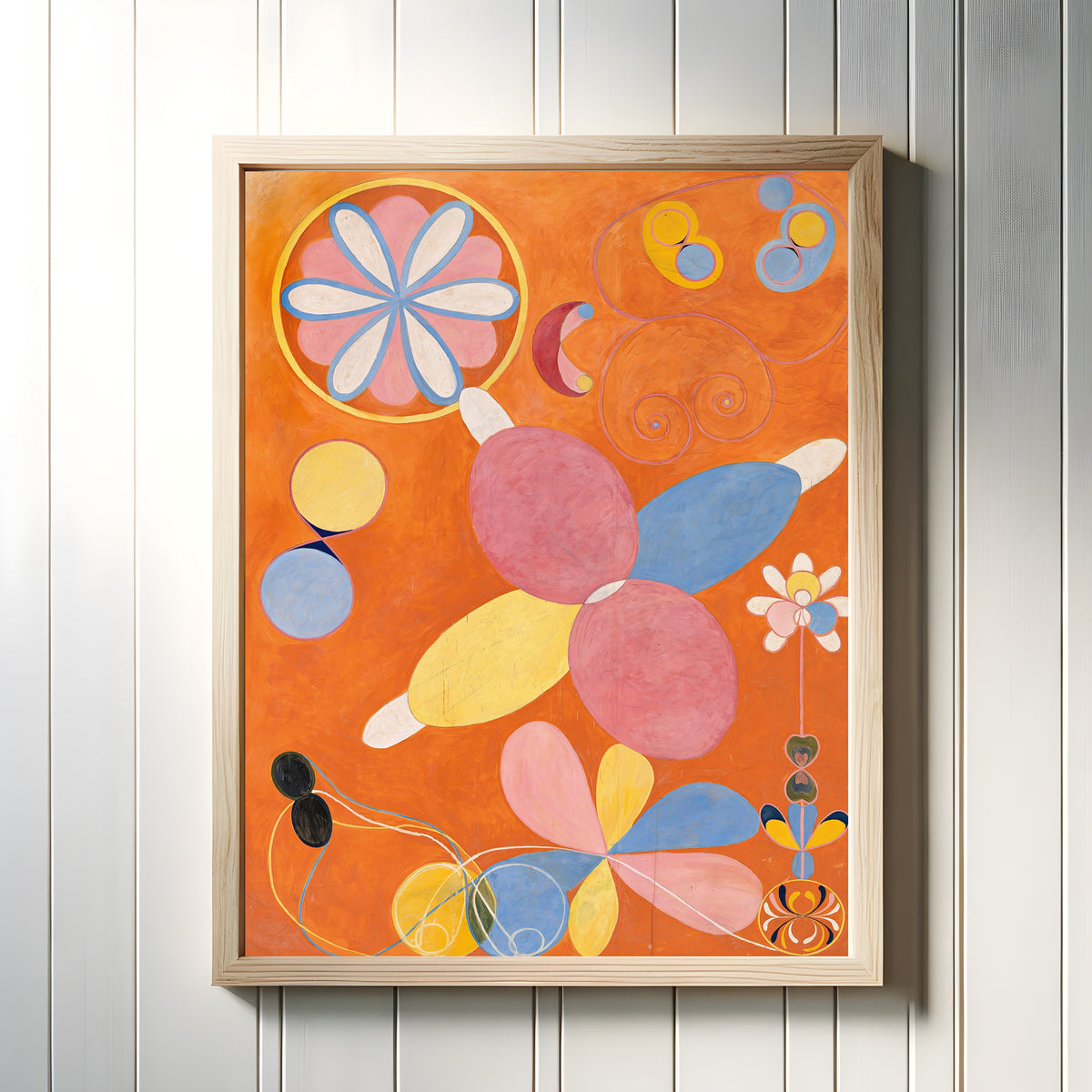 Framed art print of The Ten Largest, No. 4, Youth by Hilma af Klint, in a light wood frame on a white panelled wall