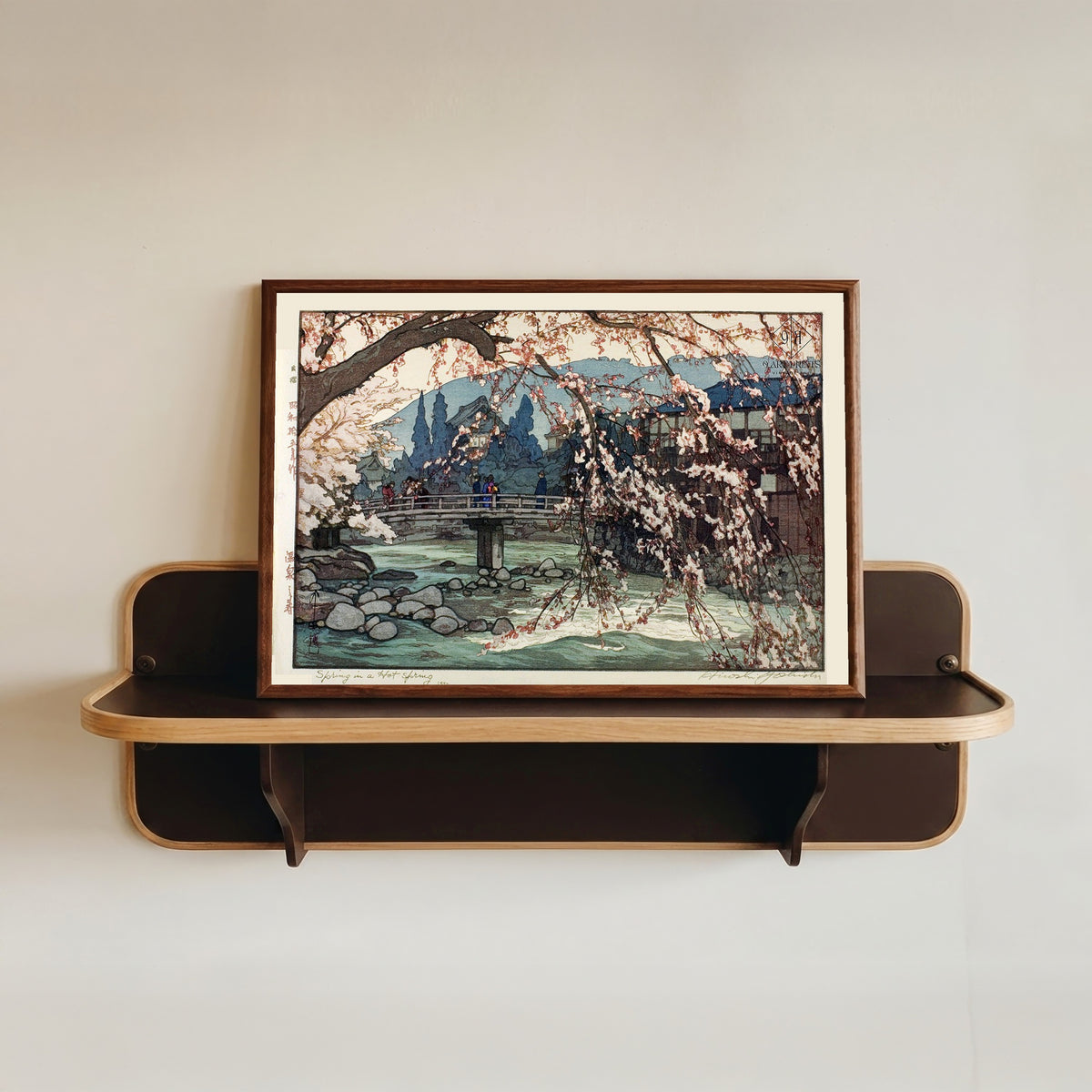 Framed art print of Spring Spa by Hiroshi Yoshida, in a dark wood frame resting on a wall shelf