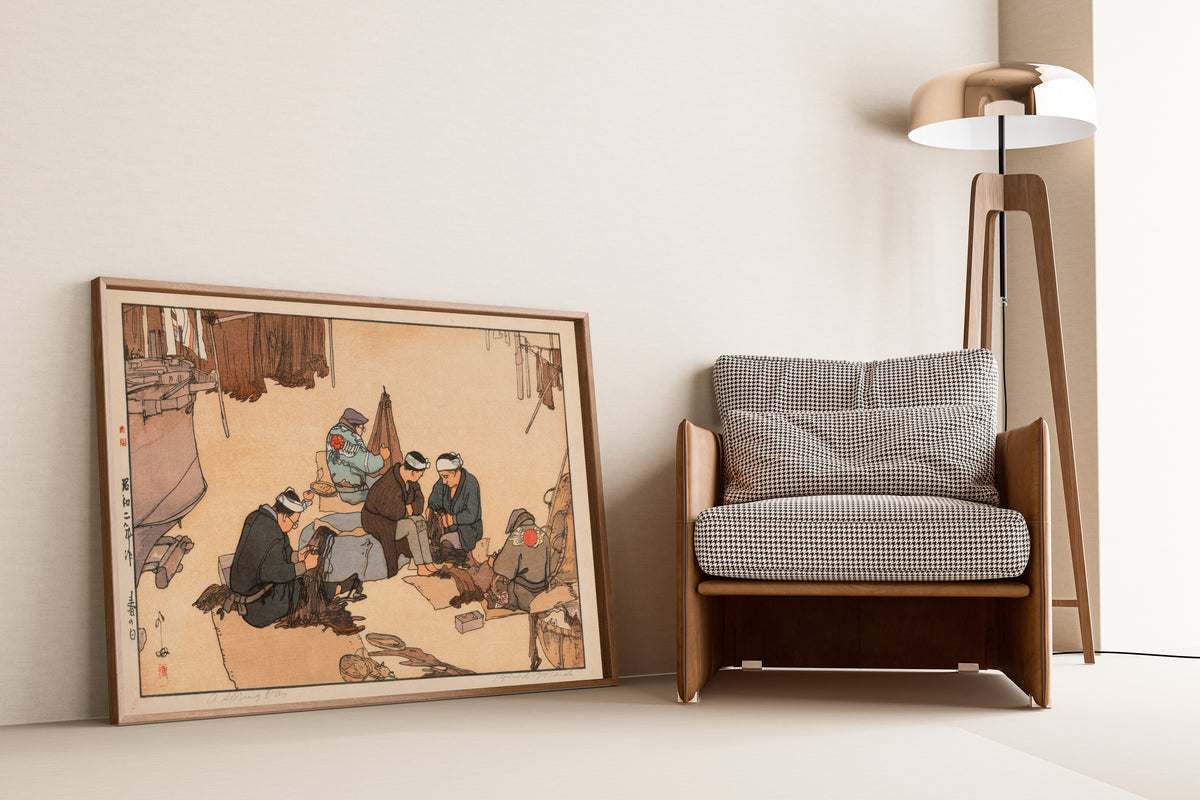 Framed art print of A Spring Day by Hiroshi Yoshida, leaning against a wall beside an armchair and a floor lamp