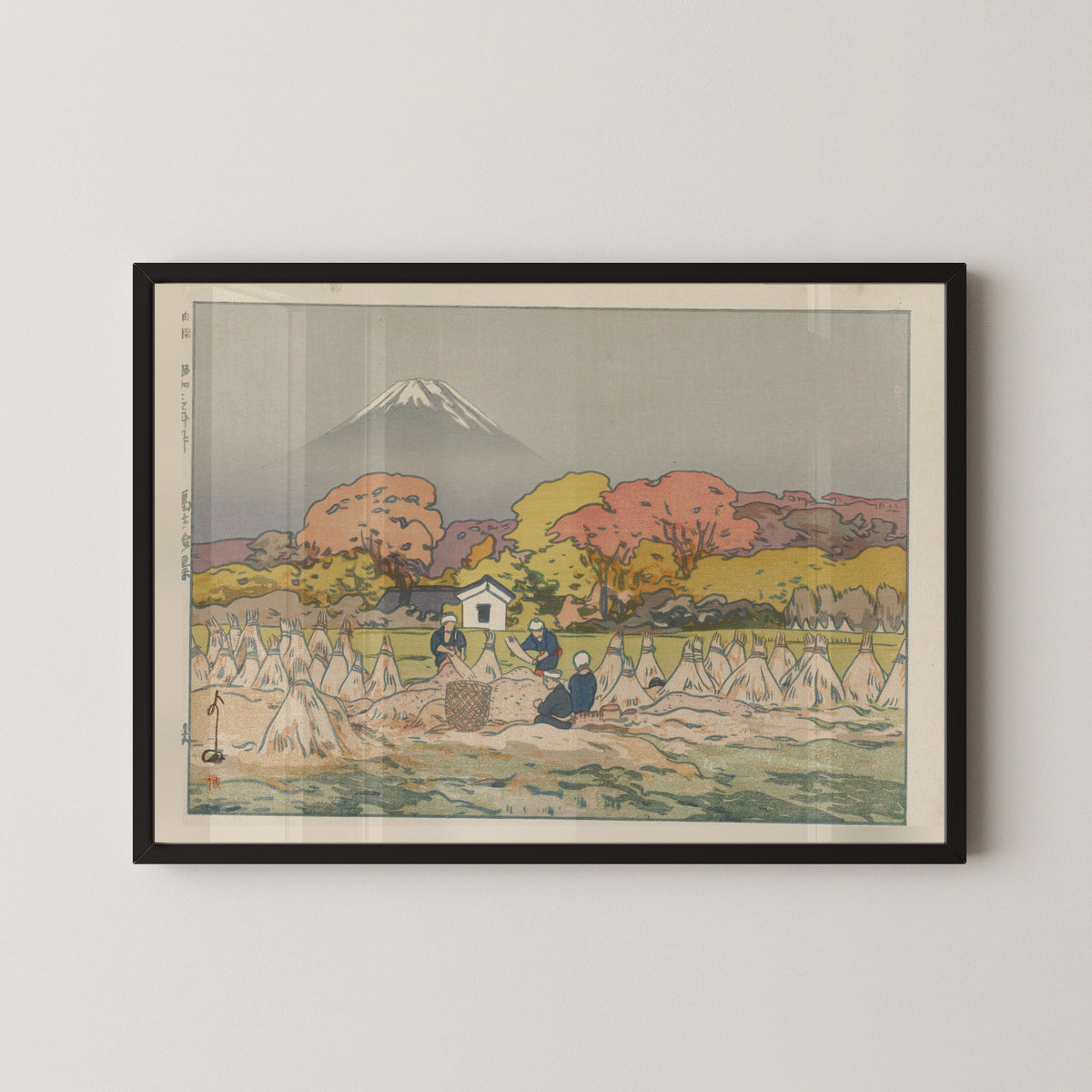 Framed art print of Autumn by Hiroshi Yoshida, in a black frame on a pale wall